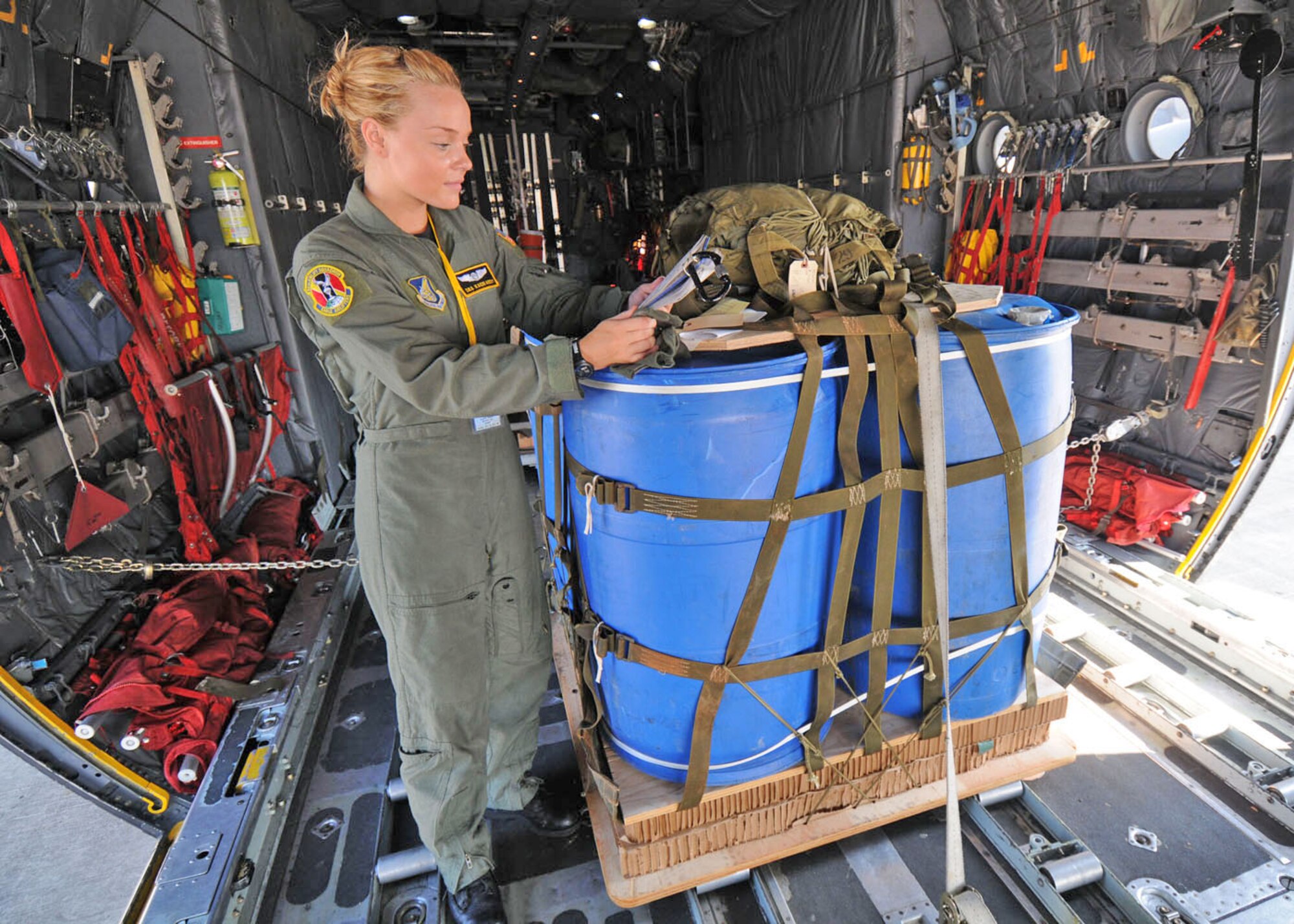 Senior Airman Kacie Adsit reads through technical orders before a heavy equipment drop from a C-130 Hercules Aug. 19 at Subang Royal Mayaysian Air Force Base, Malaysia. She is participating in Pacific Airlift Rally 2009. Airman Adsit is a 36th Airlift Squadron loadmaster from Yokota Air Base, Japan. (U.S. Air Force photo/Staff Sgt. Veronica Pierce) 