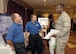 Maj. Noland Greene, commander of the 34th Combat Communications Squadron, talks with Canoga Perkins representatives Jim Maguire, left, and Keith Wynn during the AFCEA Information Technology Expo held Aug. 11 and 12 at the Tinker Club.  “I’m looking at options that will make us lighter, leaner,” said Major Greene. (Air Force photo by Margo Wright)