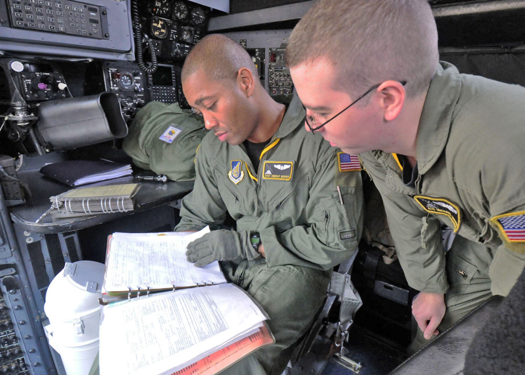 Staff Sgt. Undray Morris (left) and Airman 1st Class Michael Mason check some C-130 Hercules forms before takeoff Aug. 19 at Subang Royal Mayaysian Air Force Base, Malaysia. The Airmen are participating in Pacific Airlift Rally 2009. Sergeant Morris is a 36th Airlift Squadron flight engineer, and Airman Mason is a 36th AS loadmaster. (U.S. Air Force photo/Staff Sgt. Veronica Pierce)