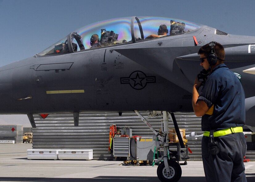 BAGRAM AIRFIELD, Afghanistan - Senior Airman Matthew Jones (front seat), a native of Warfield, Va., and Staff Sgt. Robert Burton (back seat), a native of Louisville, Ky., stay in constant communication with Senior Airman Daniel Scerri (on the ground), a native of Apex, N.C., during an inspection. This important inspection also called an "M-BIT" assures the flight controls are working properly Aug. 20. All three of the Airmen are from the 336th Expeditionary Fighter Squadron and are deployed from Seymour Johnson Air Force Base, N.C. (U.S. Air Force photo/Senior Airman Felicia Juenke)