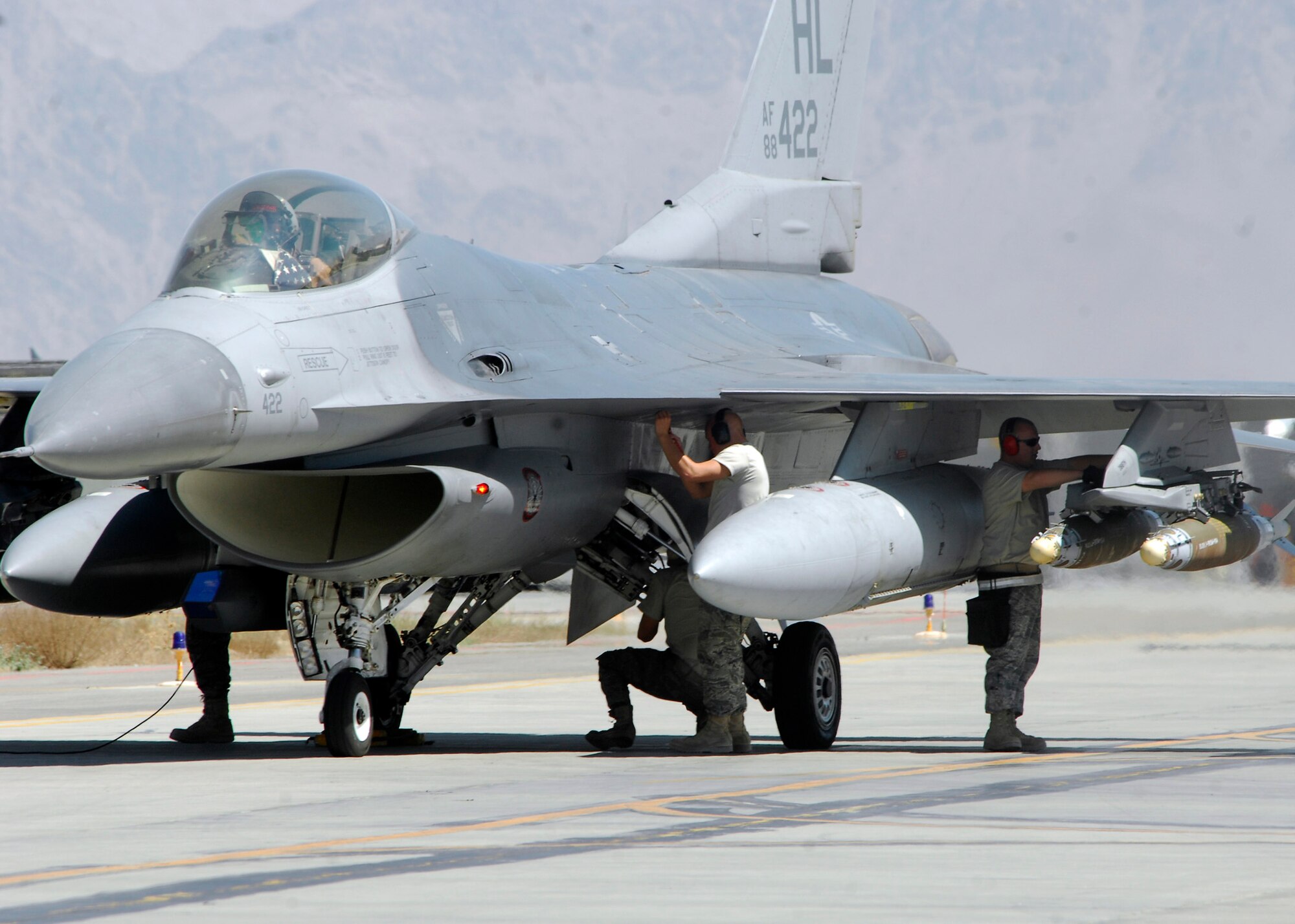 BAGRAM AIRFIELD, Afghanistan - Airmen, from the 421st Expeditionary Fighter Squadron, perform a final safety inspection before the F-16 takes off for its mission, here Aug. 20. The aircraft launched from Bagram to provide security for the Afghan people on their second national election day. The F-16s and the Airmen from the 421st EFS are deployed from Hill Air Force Base, Utah. (U.S. Air Force photo/Senior Airman Felicia Juenke)