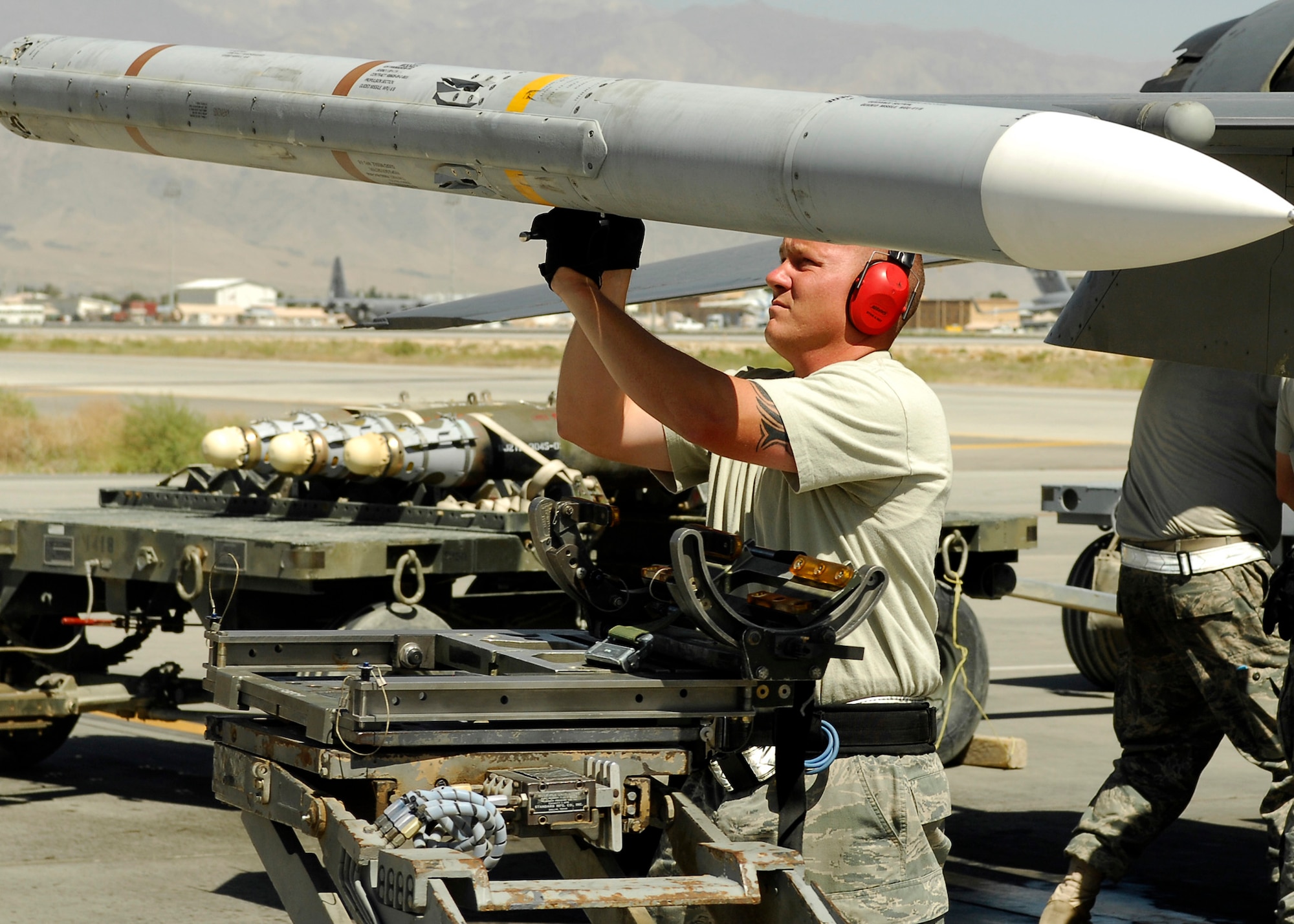 BAGRAM AIRFIELD, Afghanistan - Staff Sgt. Chad Wright, from the 421st Expeditionary Fighter Squadron, secures a missile to an F-16 Fighting Falcon, here Aug. 20. The aircraft launched from Bagram to provide security to the Afghan people on their election day. Sergeant Wright, a native of Amarillo, Texas, is deployed from the 421st Fighter Squadron at Hill Air Force Base, Utah. (U.S. Air Force photo/Senior Airman Felicia Juenke)