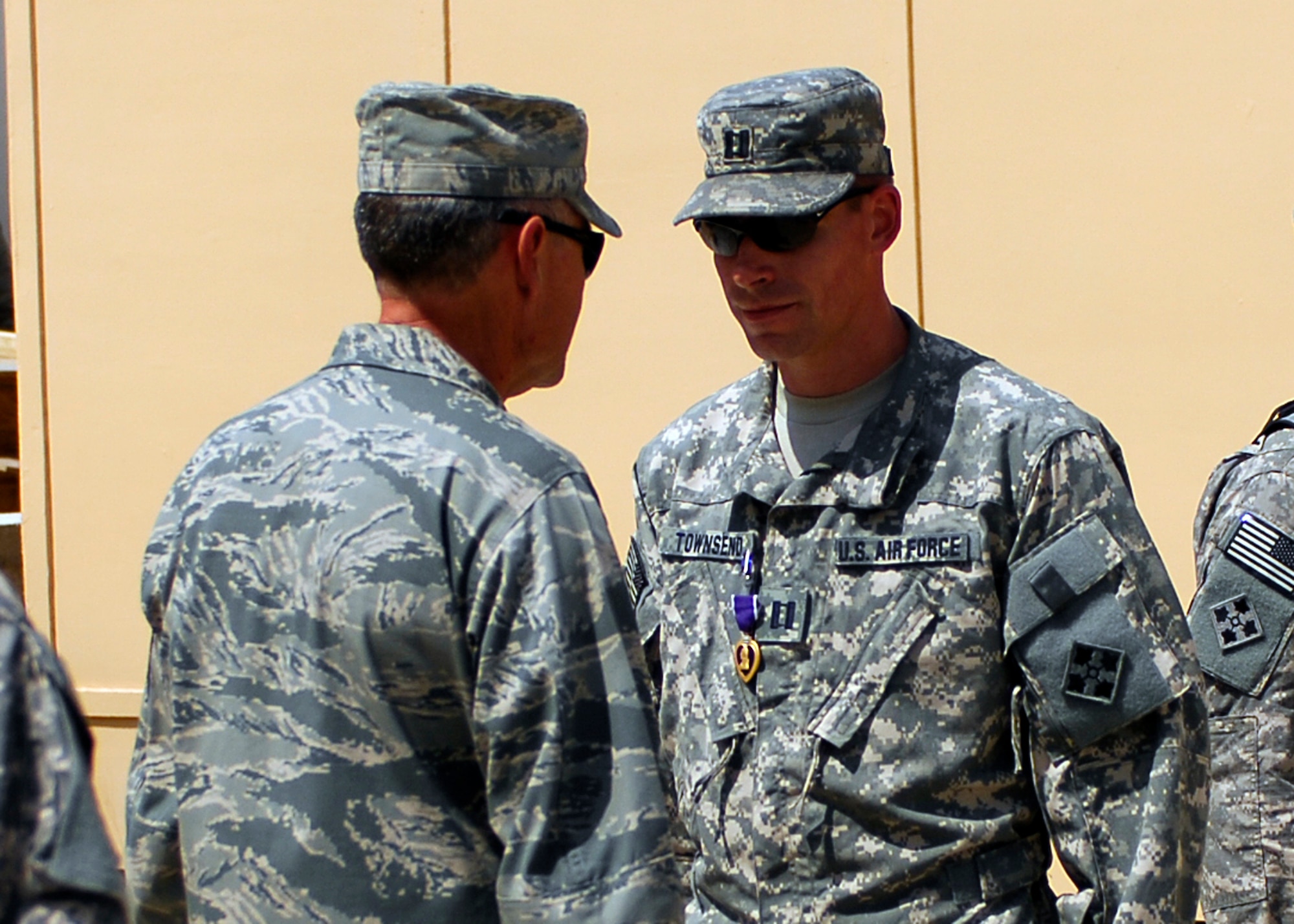 BAGRAM AIRFIELD, Afghanistan - Colonel James Meersman (left) awards the Purple Heart to Capt. Clint Townsend (right), the Laghman PRT senior engineer, for being wounded in combat, Aug. 17. Captain Townsend was on a mission supporting Operation Enduring Freedom when he was shot by a sniper.  Captain Townsend, a native of Alaska, is deployed from Spangdahlem, Germany and graduated from Washington State University. (U.S. Air Force photo/Senior Airman Felicia Juenke)
