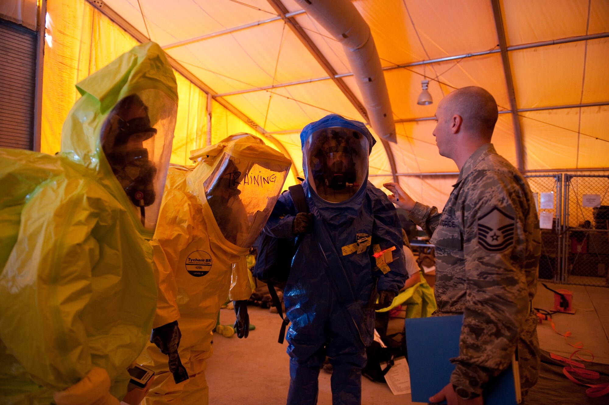 Right, Master Sgt. Michael Henderlong, 379th Expeditionary Civil Engineer Squadron readiness and emergency management flight chief, explains a simulated bioenvironmental hazardous situation to 379 ECES and 379th Expeditionary Medical Group Bioenvironmental Engineering Squadron first responders during an  exercise, Aug. 13, here. The units  trained together to better integrate responses to a bioenvironmental hazardous situation. Sergeant Henderlong is a native of Denver and is deployed from Peterson Air Force Base, Colo., in support of Operations Iraqi and Enduring Freedom. (U.S. Air Force Photo/ Staff Sgt. Robert Barney)
