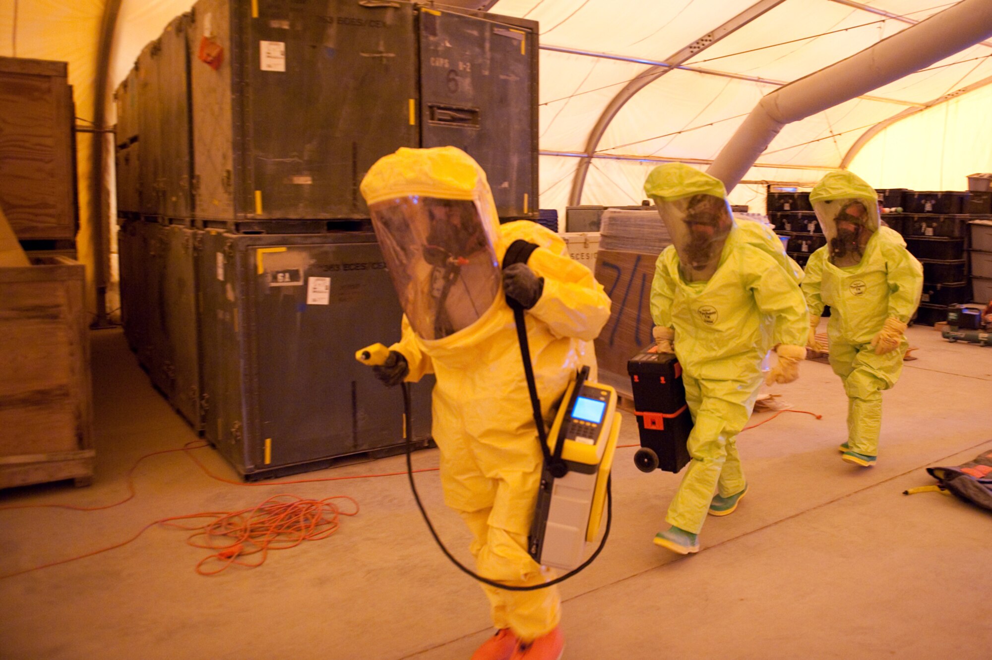 Left, Staff Sgt. Allyn Robertson, 379th Expeditionary Medical Group Bioenvironmental Engineering Squadron, Senior Airmen Casey Young and James Owen, 379th Expeditionary Civil Engineer Squadron readiness and emergency management flight, team up to identify simulated hazardous materials in a training exercise, Aug. 13, in Southwest Asia. The 379 ECES and 379 EMDG  trained together to better integrate their response to a bioenvironmental hazardous situation. Sergeant Robertson is deployed from Peterson Air Force Base, Colo.; Airman Young is deployed from Elmendorf AFB, Alaska, and Airman Owen is from Shaw AFB, S.C. All are deployed in support of Operations Iraqi and Enduring Freedom. (U.S. Air Force Photo/ Staff Sgt. Robert Barney) 