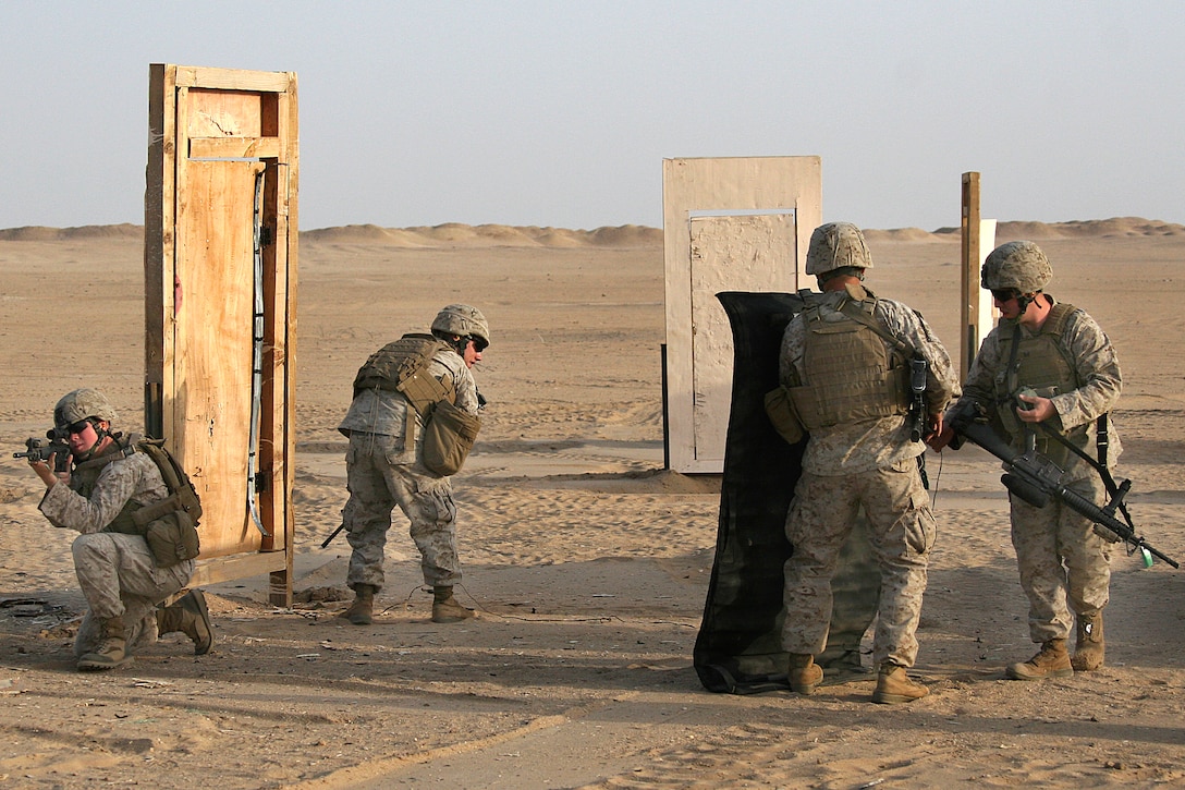 U.S. Marine combat engineers prepare to blast their way through a ...