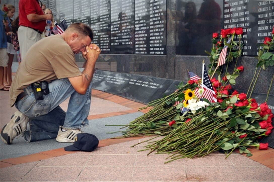 A mourner pays final respects to U.S. Navy Capt. Michael Scott Speicher at the Jacksonville Veterans Memorial Wall in Jacksonville, Fla., Aug. 14, 2009. Speicher was killed when his F/A-18 Hornet aircraft was shot down over the Anbar province of Iraq Jan. 17, 1991, on the first day of offensive operations during Operation  Desert Storm. 