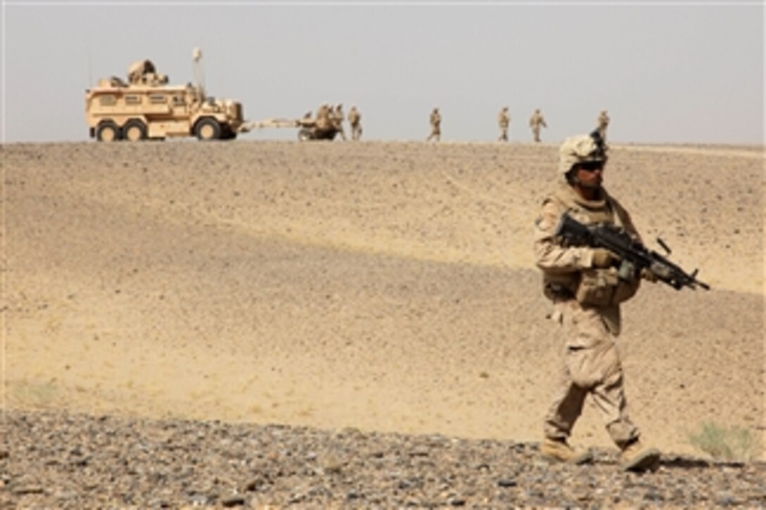 U.S. Marine Corps Cpl. William Medina, an amphibious assault vehicle crewman, walks through the desert during a census patrol in Helmand province, Afghanistan, on Aug. 18, 2009.  Delta Company, 2nd Amphibious Assault Battalion and civil affairs group Marines, deployed with the 2nd Marine Expeditionary Brigade, are talking with the local populace in order to understand their conditions and concerns and identify possible reconstruction and development projects.  Delta Company Marines are deployed with Regimental Combat Team 3 to conduct counterinsurgency operations in partnership with the Afghan national security forces in southern Afghanistan.  