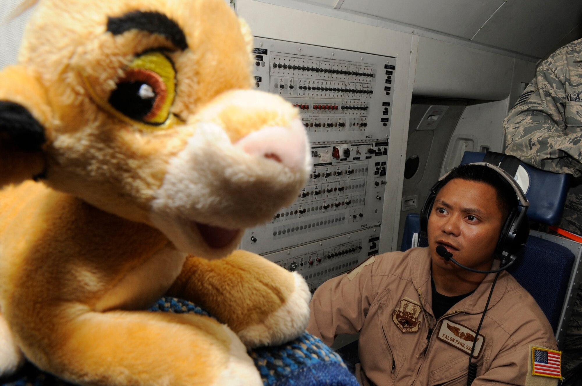 SOUTHWEST ASIA- Staff Sgt. Kalon Pang, 964th Expeditionary Airborne Air Control Squadron, checks his radar in flight during an exercise Aug. 21. Sergeant Pang brings a small stuffed lion with him on every flight, and intends on giving it to his son when he returns home. Sergeant Pang's son is not yet born, so he is saving the little stuffed lion to give it to him when he arrives in about three months. Sergeant Pang is deployed from Tinker AFB, Okla., and hails from Caguas, Puerto Rico.(U.S. Air Force photo/Senior Airman Stephen Linch) 