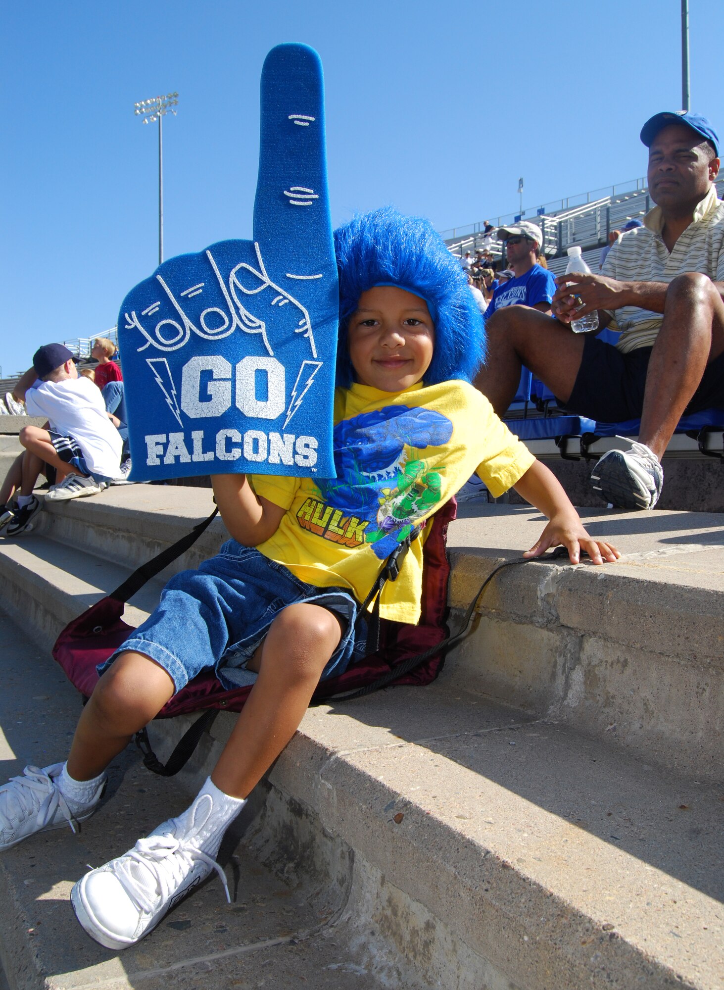 Jonathan Terrence Durant, age 5, poses for a photo in Falcon Stadium at the U.S. Air Force Academy, Colo., Aug. 22, 2009. Jonathan and about 1,000 other fans, large and small, attended a Falcons scrimmage at the stadium and stayed afterward to meet the 2009 football team. Jonathan's father, Col. James Durant (right), is deputy department head for the Department of Law. (U.S. Air Force photo/Staff Sgt. Don Branum)