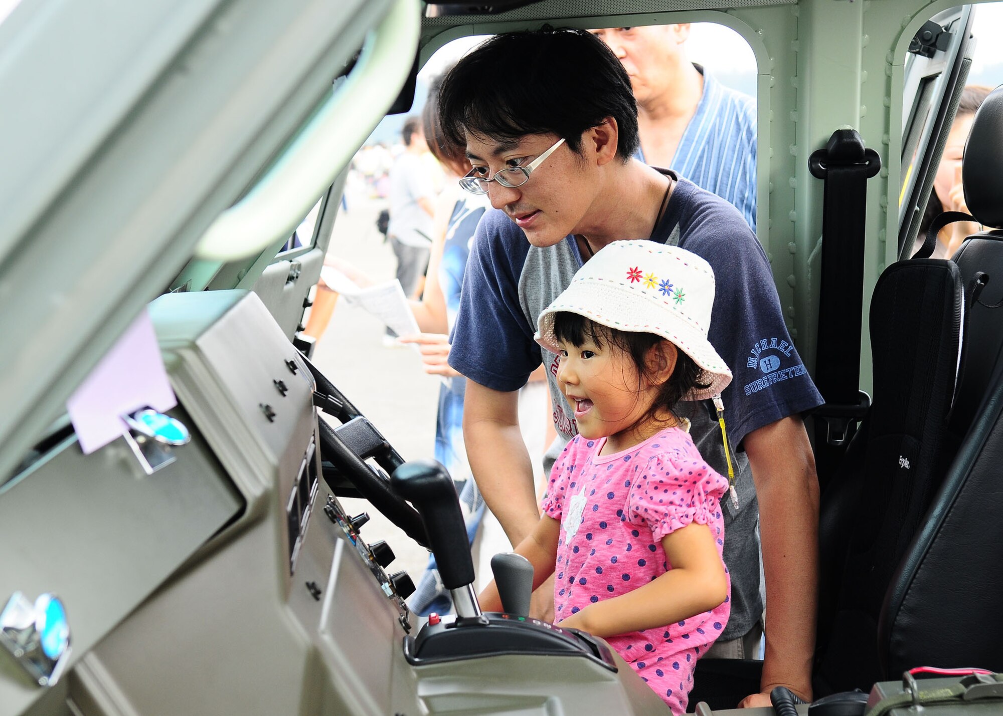YOKOTA AIR BASE, Japan -- A father and daughter check out the interior of a Japan Self-Defense Force vehicle Aug 22 at the Yokota Air Base Japanese-American Friendship Festival Aug. 22. In addition to static displays and live music, the festival offered a variety of American and Japanese food items. The festival is designed to bolster the bi-lateral relationship shared by the United States and Japan. (U.S. Air Force photo/Airman 1st Class Sean Martin)
