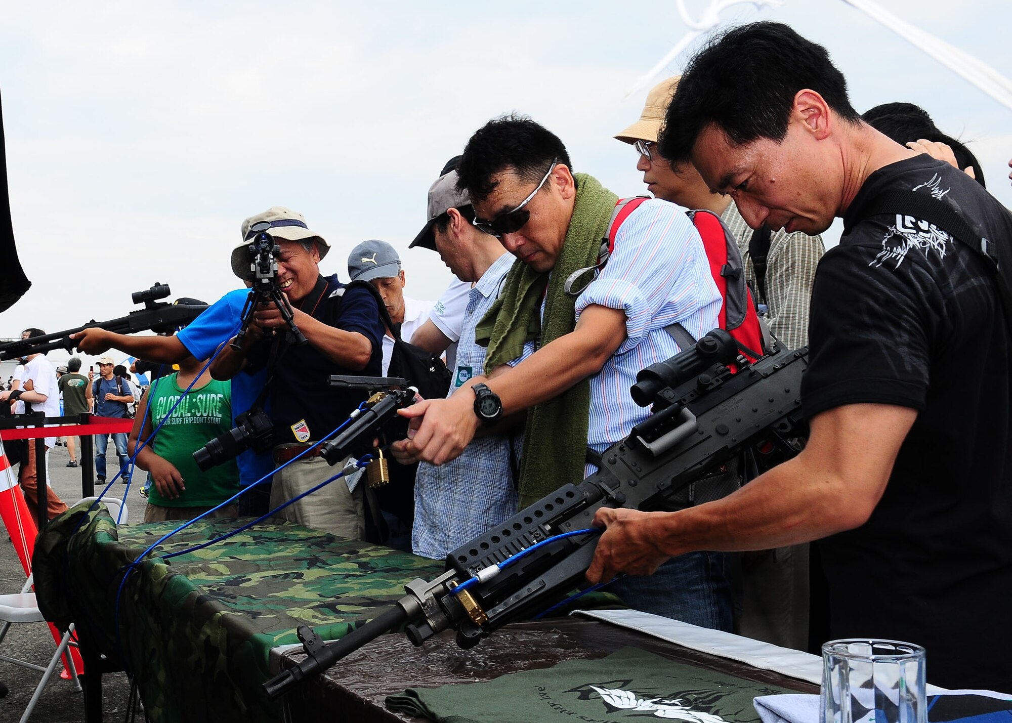 YOKOTA AIR BASE, Japan -- Festival goers look at a weapons display Aug. 22 during the 2009 Yokota Air Base Japanese-American Friendship Festival. More than 80,000 people attended the first of two days. In addition to static displays and live music, the festival offered a variety of American and Japanese food items. The festival is designed to bolster the bi-lateral relationship shared by the United States and Japan.(U.S. Air Force photo/Airman 1st Class Sean Martin)