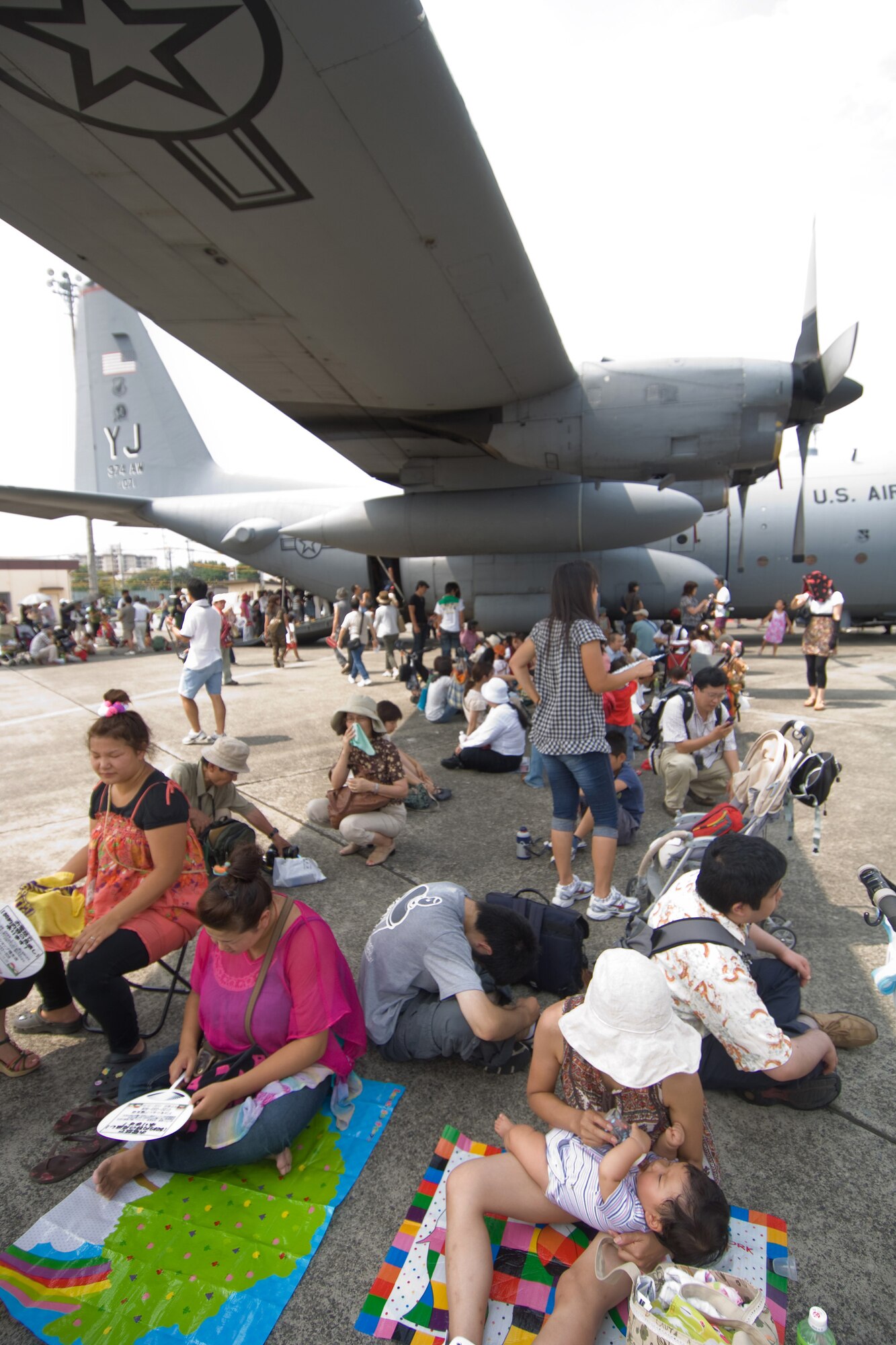 YOKOTA AIR BASE, Japan -- More than 80,000 people attended the first day of the two-day Yokota Air Base Japanese-American Friendship Festival Aug. 22. Festival goers found shade wherever they could to beat 90-degree temperatures. In addition to static displays and live music, the festival offered a variety of American and Japanese food items. The festival is designed to bolster the bi-lateral relationship shared by the United States and Japan. (U.S. Air Force photo/Osakabe Yasuo)