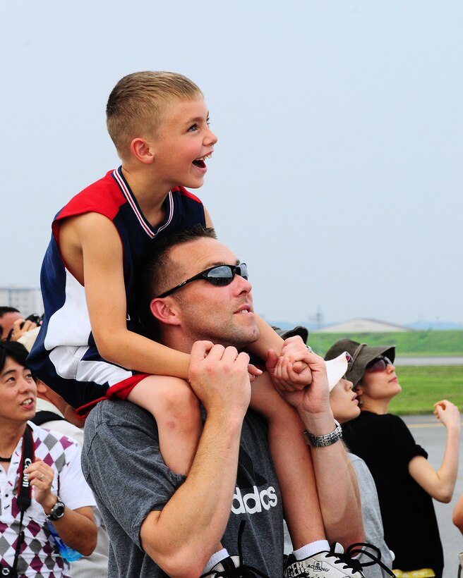 YOKOTA AIR BASE, Japan -- Eric Epperson and son Chase watch as a U-2S "Dragon Lady" from the 5th Reconnaissance Squadron flies by Aug. 22 during the 2009 Yokota Air Base Japanese-American Friendship Festival. More than 80,000 people attended the first day of the two-day festival designed to bolster the bi-lateral relationship shared by the United States and Japan. (U.S. Air Force photo/Airman 1st Class Michael Dillon)  