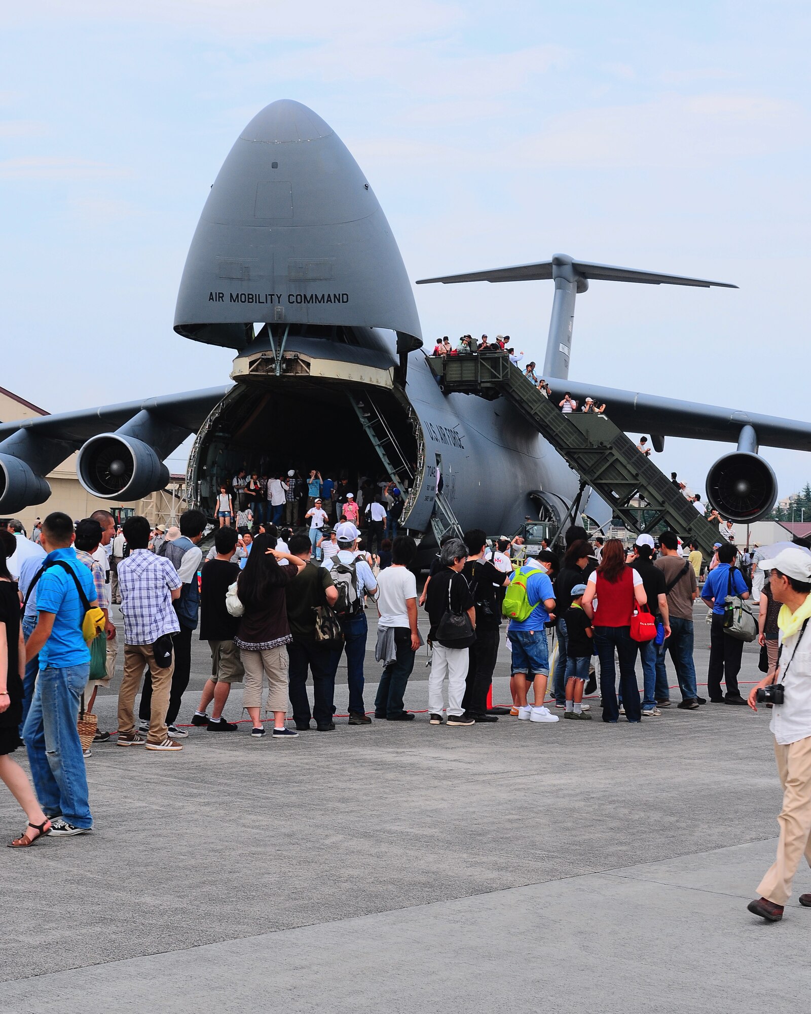 YOKOTA AIR BASE, Japan -- Festival goers wait in line to view the inside of a C-5 Galaxy during the 2009 Yokota Air Base Japanese-American Friendship Festival. More than 80,000 people attended the first day of the two-day festival designed to bolster the bi-lateral relationship shared by the United States and Japan. (U.S. Air Force photo/Airman 1st Class Michael Dillon)  