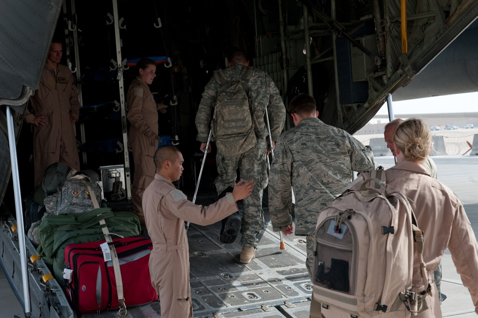 Airmen from the 379th Expeditionary Aeromedical Evacuation Squadron help load medical patients onto a C-130 for transportation, Aug. 15, in Southwest Asia. The 379 EAES provides a regular "mercy mission," which transports patients from throughout Southwest Asia to established medical care facilities. All EAES Airmen are deployed in support of Operations Iraqi and Enduring Freedom. (U.S. Air Force Photo/ Staff Sgt. Robert Barney) 