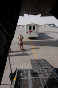 Tech. Sgt. Cory Preusse, 746th Expeditionary Airlift Squadron loadmaster, positions a medical transportation bus behind a C-130, Aug. 15, in Southwest Asia. The 746 EAS assists with providing a regular "mercy mission," to transport patients from throughout Southwest Asia to established medical care facilities. Sergeant Preusse is deployed from the Minnesota Air National Guard in support of Operations Iraqi and Enduring Freedom. (U.S. Air Force Photo/ Staff Sgt. Robert Barney) 