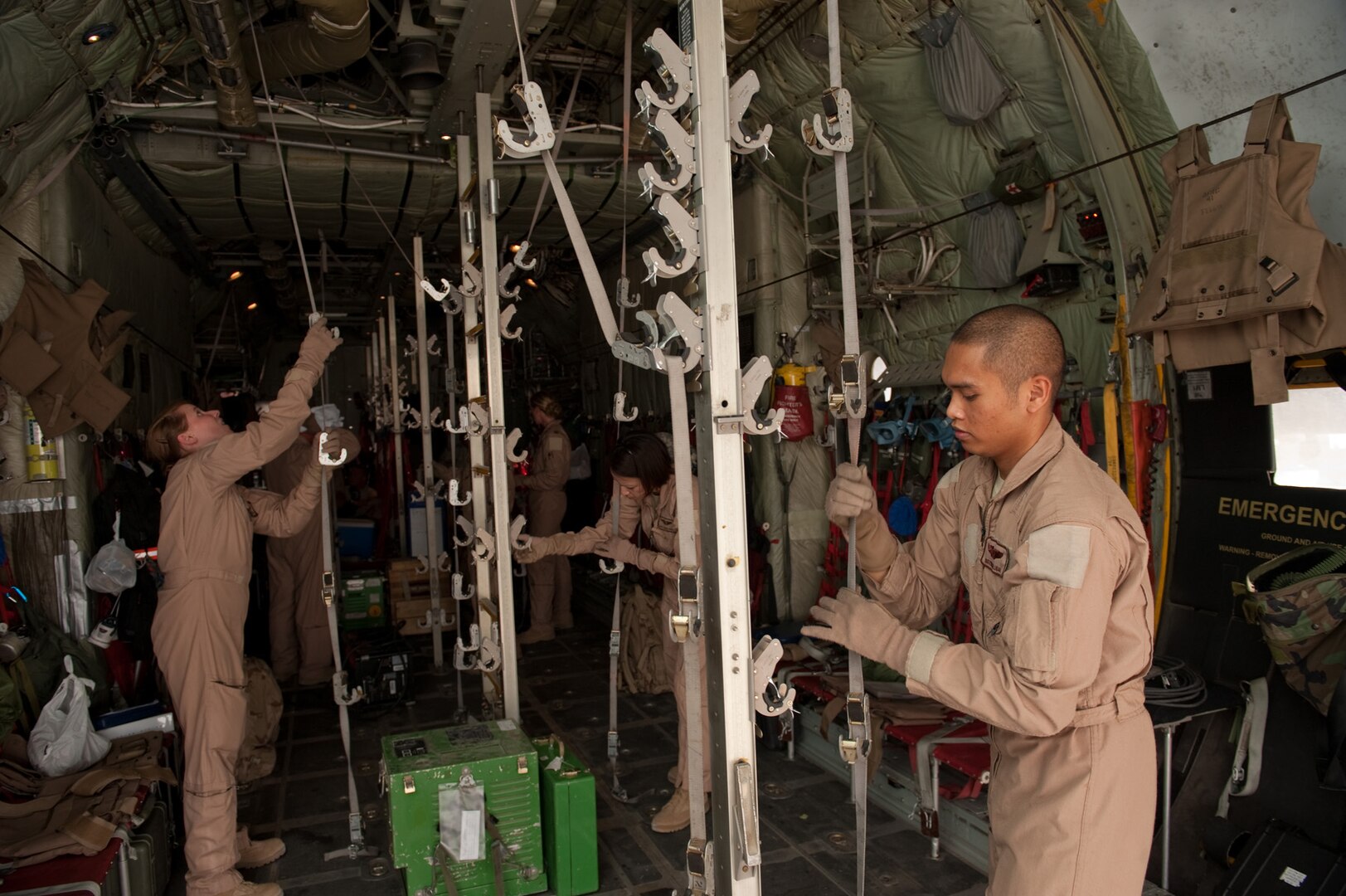 Aeromedical Evacuation Technician Staff Sgt. Ryan Balubar, along with fellow Airmen from the 379th Expeditionary Aeromedical Evacuation Squadron, prepares a C-130 to transport medical patients, Aug. 15, in Southwest Asia. The 379 AES provides a regular "mercy mission," which transports patients from throughout Southwest Asia to established medical care facilities. Sergeant Balubar is deployed from Kadena Air Base, Japan, in support of Operations Iraqi and Enduring Freedom. (U.S. Air Force Photo/ Staff Sgt. Robert Barney) 