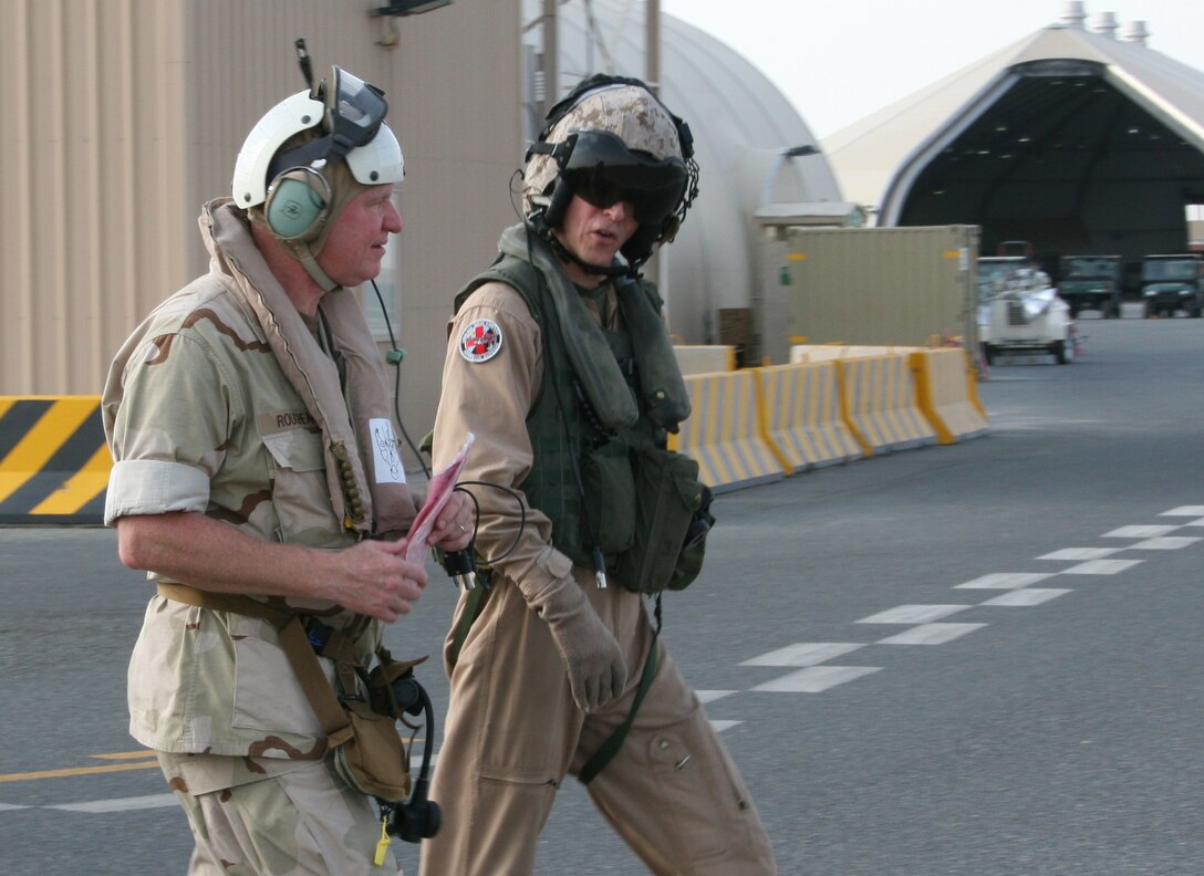 Chief of Naval Operations Adm. Gary Roughead, left, and Maj. Brett A. Hart, the assistant operations officer for Marine Medium Tiltrotor Squadron 263 (Reinforced), 22nd Marine Expeditionary Unit, walk to an MV-22B Osprey after a visit to Camp Buehring, Kuwait, Aug. 22, 2009. Roughead visited the Marines and sailors of the 22nd MEU who are conducting sustainment training ashore in Kuwait while serving as the theater reserve force for U.S. Central Command.
