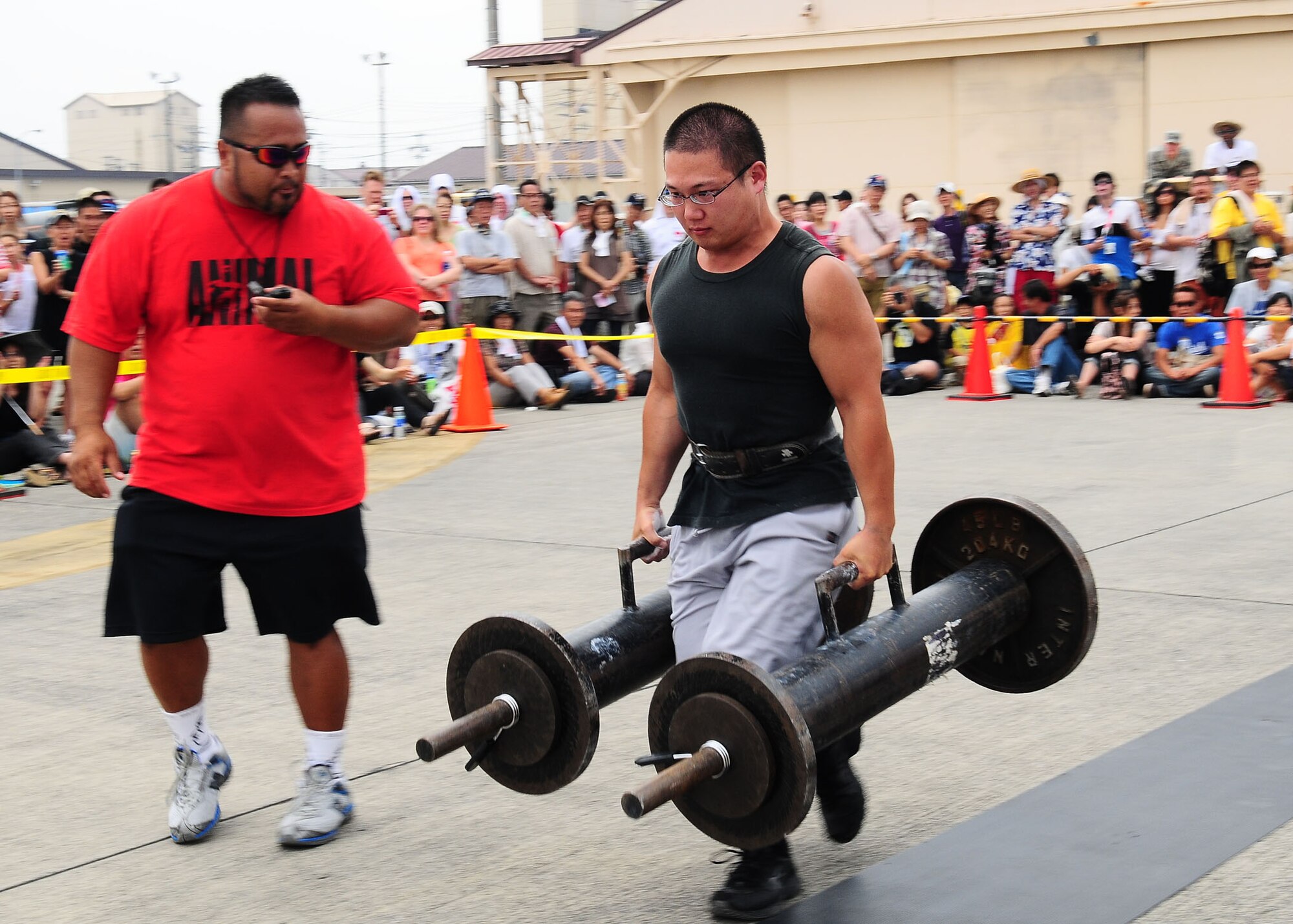 YOKOTA AIR BASE, Japan -- Yashihito Noritake, a participant in the 6th AnnualYokota Air Base Strongman Challenge, competes in the farmer's walk event Aug. 23 during the 2009 Yokota Air Base Japanese-American Friendship Festival.  More than 170,000 people attended the two-day event. In addition to static displays and live music, the festival offered a variety of American and Japanese food items. The festival is designed to bolster the bi-lateral relationship shared by the United States and Japan. (U.S. Air Force photo/Airman 1st Class Sean Martin)