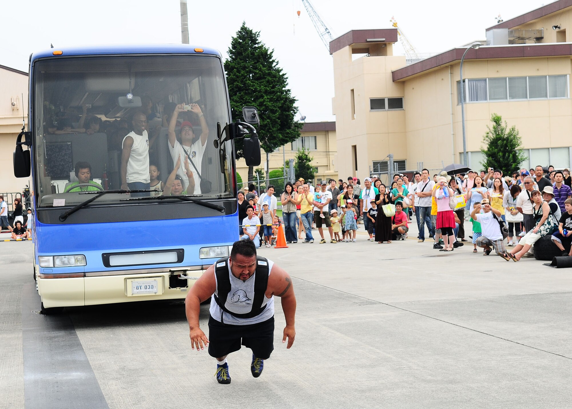 YOKOTA AIR BASE, Japan -- Grant Higa, special guest at the 6th Annual Yokota Air Base Strongman Competition, pulls a bus full of passengers during the 2009 Yokota Air Base Japanese-American Friendship Festival Aug. 23.  More than 170,000 people attended the two-day event. In addition to static displays and live music, the festival offered a variety of American and Japanese food items. The festival is designed to bolster the bi-lateral relationship shared by the United States and Japan. (U.S. Air Force photo/Airman 1st Class Sean Martin)