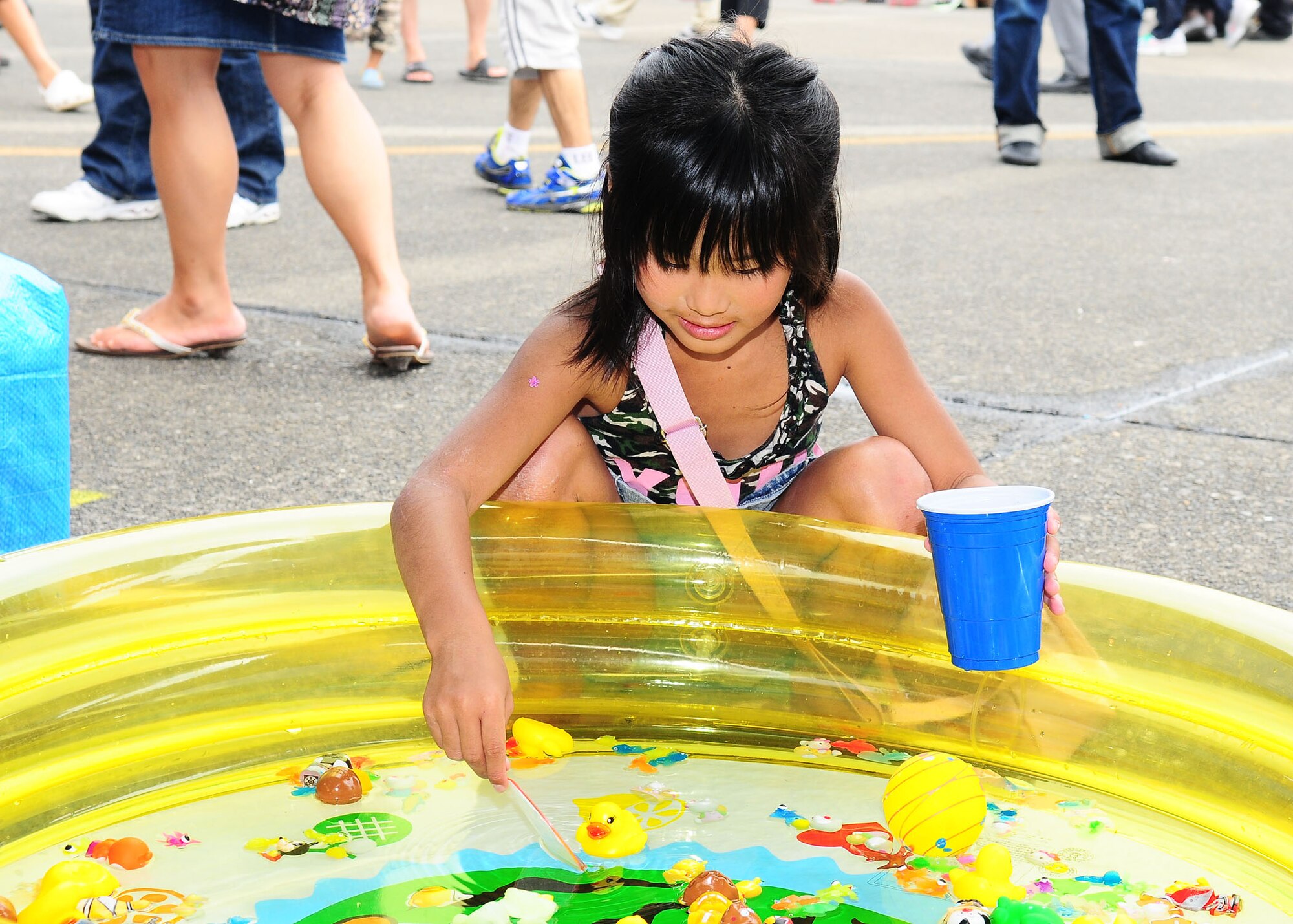 YOKOTA AIR BASE, Japan -- Nanami Tsugi "fishes" for a prize during the 2009 Yokota Air Base Japanese-American Friendship Festival. More than 170,000 people attended the two-day event. In addition to static displays and live music, the festival offered a variety of American and Japanese food items. The festival is designed to bolster the bi-lateral relationship shared by the United States and Japan. (U.S. Air Force photo/Airman 1st Class Sean Martin)