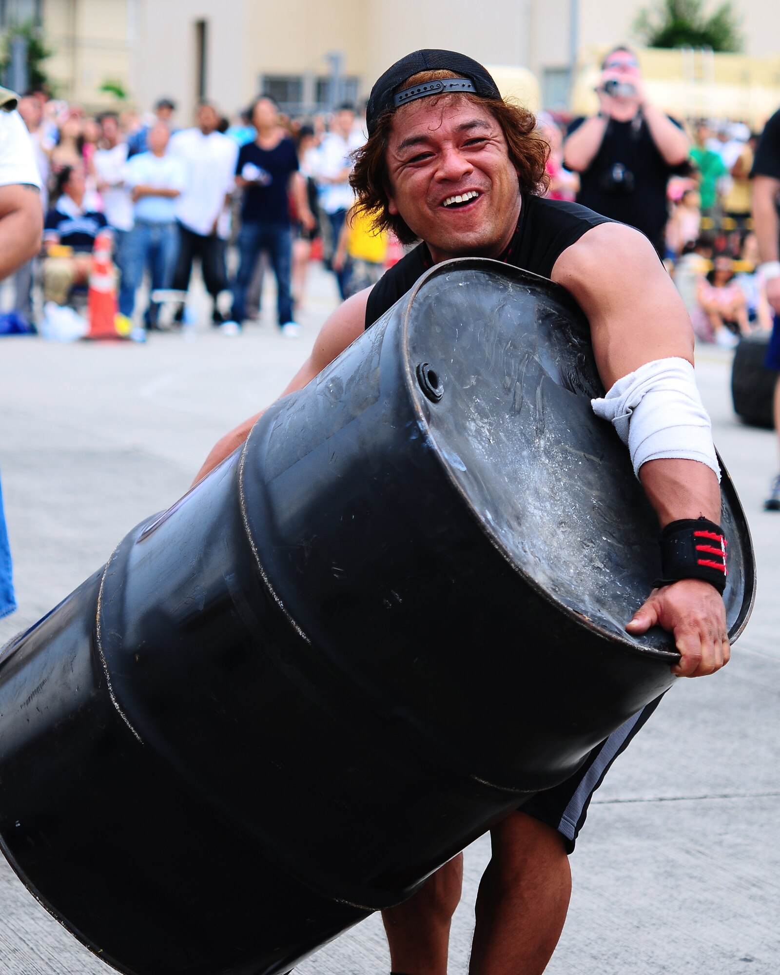YOKOTA AIR BASE, Japan -- Nagao Tutomu, a participant in the 6th Annual Yokota Strongman Competition, competes during the 2009 Yokota Air Base Japanese-American Friendship Festival Aug. 23. More than 170,000 people attended the two-day event. In addition to static displays and live music, the festival offered a variety of American and Japanese food items. The festival is designed to bolster the bi-lateral relationship shared by the United States and Japan. (U.S. Air Force photo/Airman 1st Class Michael Dillon)
