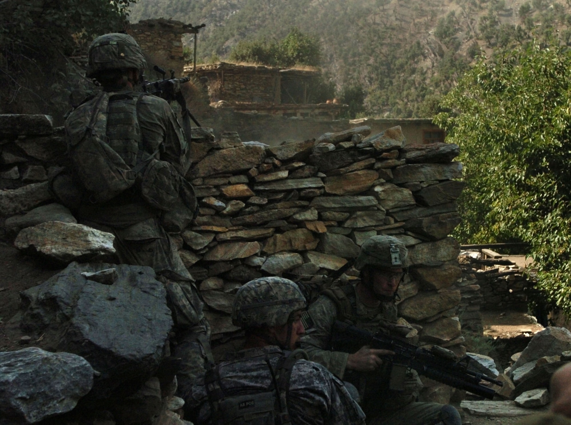 KORENGAL VALLEY, Afghanistan - Baker Company, 2nd Battalion, 12th Infantry Regiment, 4th Brigade Combat Team, 4th Infantry Division, servicemembers return fire at insurgent positions in the Korengal Valley’s steep hillside in Afghanistan’s Kunar province, Aug. 13. (U.S. Army photo/Sgt. Matthew Moeller)