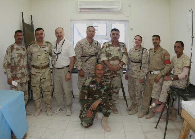 Members of the 7th Iraqi Army Division’s medical staff along with Senior Chief Petty Officer Rey De La Cruz (fourth from left), the senior enlisted advisor with Combat Logistics Battalion 7, 2nd Marine Logistics Group (Forward)’s battalion aid station, and Petty Officer 3rd Class Jennifer Ybarra (third from right), a hospital corpsman at the BAS, pose for a photograph after a class given by the corpsmen on sports injuries aboard Camp Mejid, Iraq, Aug. 24, 2009.  Corpsmen from CLB-7’s BAS have been conducting training with the IA medical staff since the battalion’s arrival in February 2009. (U.S. Marine Corps photograph by Lance Cpl. Melissa A. Latty)
