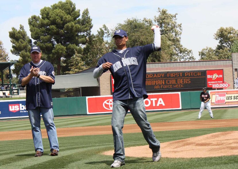 Senior Airman Jason Childers, a 573rd Global Support Squadron personnel journeyman at Travis Air Force Base, Calif., throws out the first pitch at a Sacramento River Cats game Aug. 23, 2009, in Sacramento. Cheering on the Airman is Col. John Lipinski, 615th Contingency Response Wing commander, also from Travis. The first pitch was one of several events leading up to Air Force Week Sacramento 2009 in September. (U.S. Air Force Photo/Staff Sgt. Meredith Mingledorff) 
