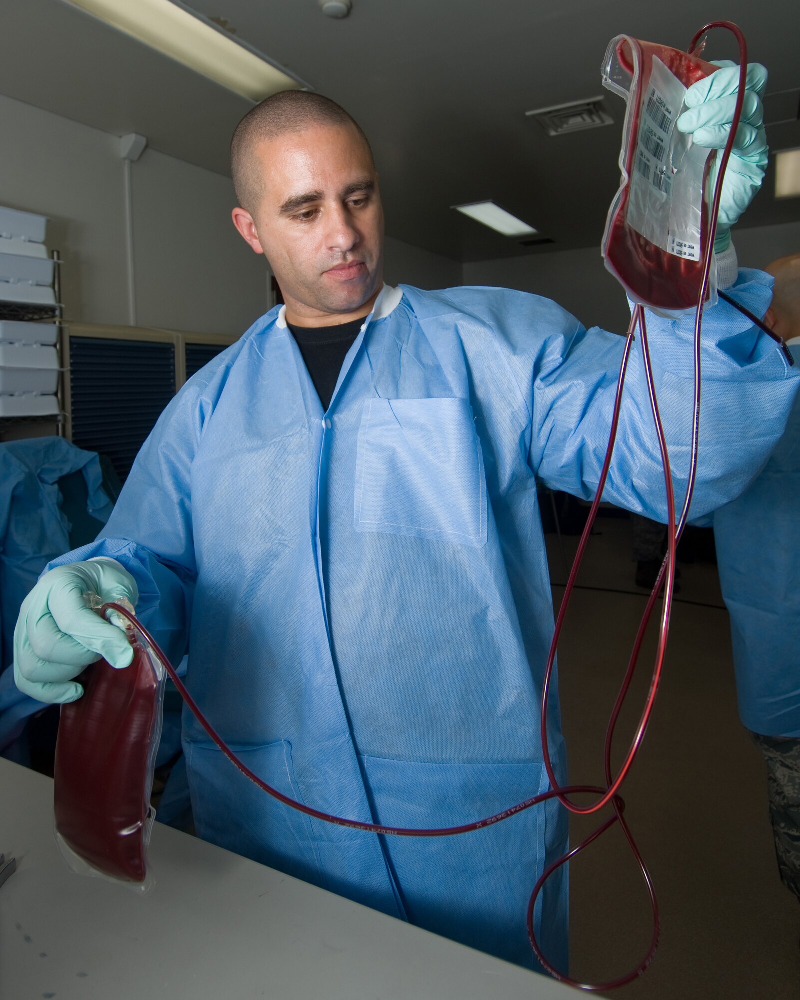 YOKOTA AIR BASE, Japan -- Tech. Sgt. Marcus Houston, 35th Medical Support
Squadron on temporary duty from Misawa Air Base, Japan, ensures washed red blood cells flow into the primary collection bag during Blood Deglycerolization Team training here recently. (U.S. Air Force photo/Osakabe Yasuo)

