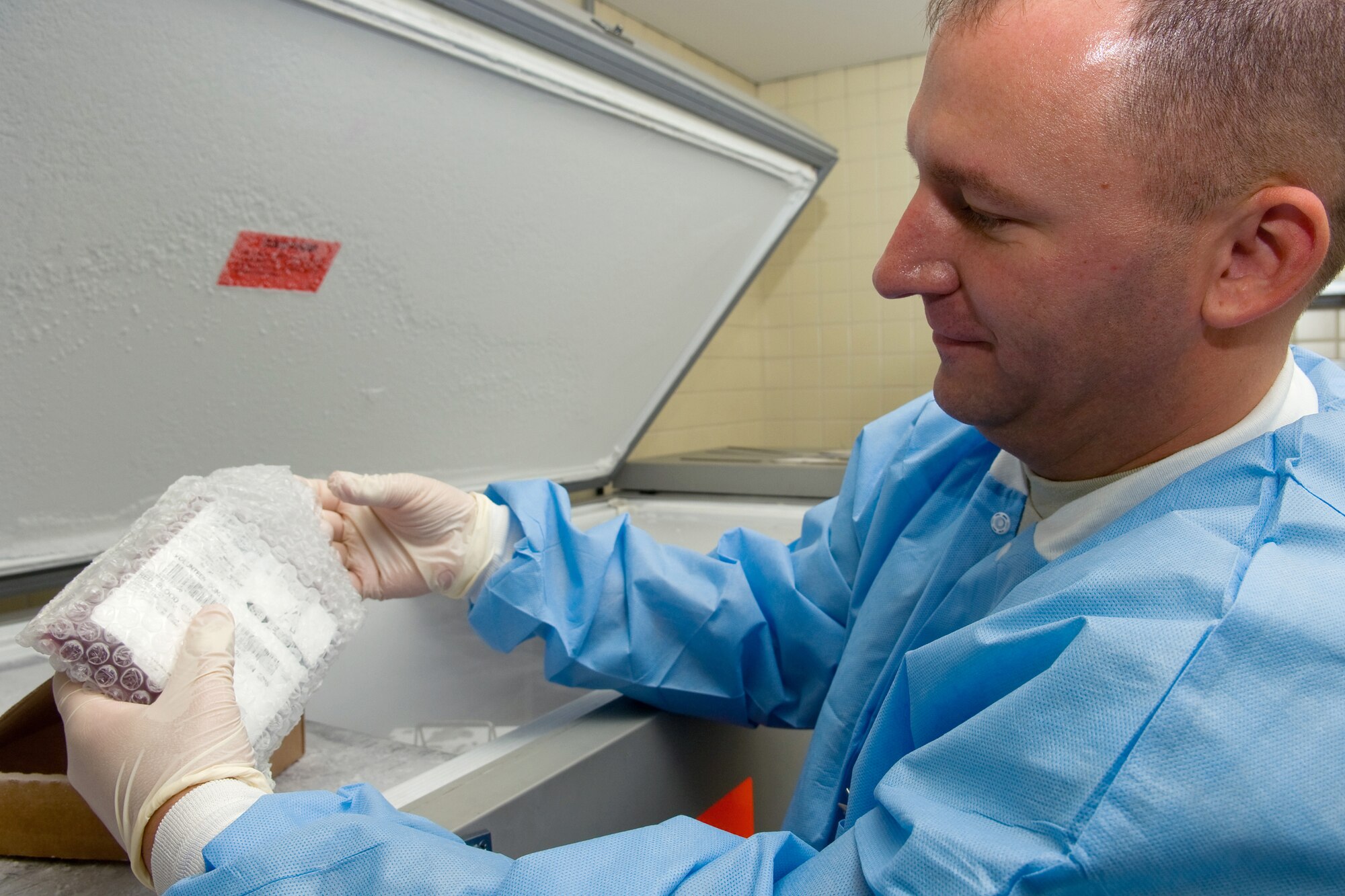 YOKOTA AIR BASE, Japan -- Master Sgt. Chad Below, a trainer from the Armed Services Whole Blood Processing Laboratory-West at Travis Air Force Base, Calif., removes blood frozen at minus 80 degrees Celsius to demonstrate the process of thawing glycerolized-frozen red cells. Yokota and Misawa Airmen recently received Blood Deglycerolization Team training at the base hospital here. The Armed Services Whole Blood Program plays a key role in providing quality blood products for servicemembers and their families in peacetime and war. The ASBP has many components working together to collect, process, store, distribute and transfuse blood
worldwide. (U.S. Air Force photo/Osakabe Yasuo)
