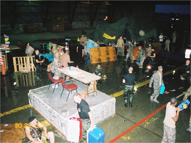 Airmen participate in the 92nd Logistics Readiness Squadron Combat Dining In that took place Jul 24 in building 1003. The event was hosted by the Maj. Breck Woodard, 92nd LRS commander. Special guests included Honorary Commander and spouse, Al and Rosalie French. The evening consisted of tribute a POW/MIA, dinner, trips to the obstacle course and GROG, and defending base camps from being infiltrated by would-be attackers with water-guns and water balloons. (Courtesy photo)