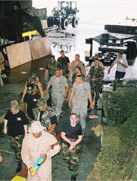 Airmen participate in the 92nd Logistics Readiness Squadron Combat Dining In that took place Jul 24 in building 1003. The event was hosted by the Maj. Breck Woodard, 92nd LRS commander. Special guests included Honorary Commander and spouse, Al and Rosalie French. The evening consisted of tribute a POW/MIA, dinner, trips to the obstacle course and GROG, and defending base camps from being infiltrated by would-be attackers with water-guns and water balloons. (Courtesy photo)