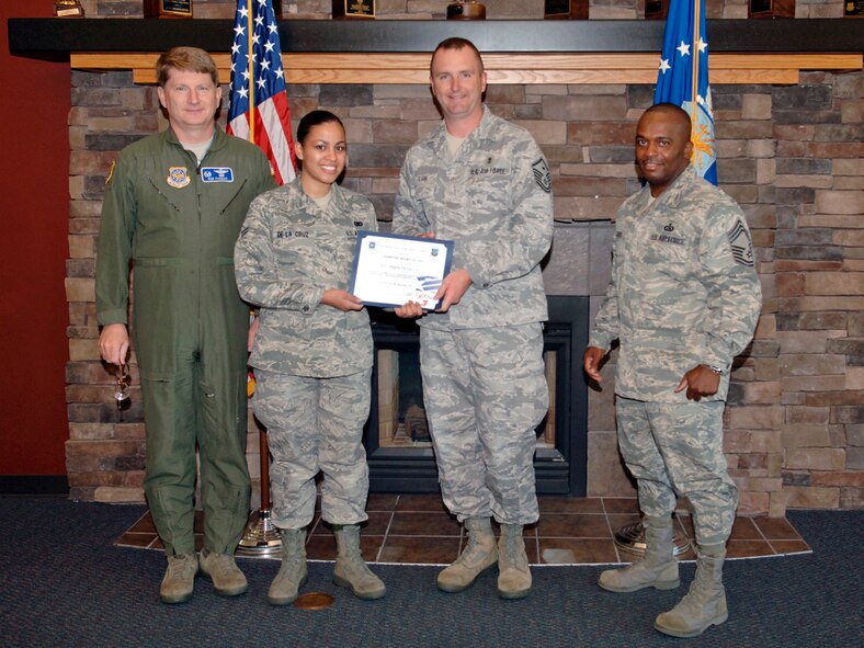 FAIRCHILD AIR FORCE BASE, Wash. – Airman 1st Class Angela De La Cruz, 92nd Logistics Readiness Squadron material management, receives the Diamond Sharp award from Col. Robert Thomas, 92nd Air Refueling Wing commander and Chief Master Sgt. Michael Davis, 92nd Mission Support Group superintendant  Aug. 11. Master Sgt. Joseph Guzik, 92nd Logistics Readiness Squadron, first sergeant, nominated Airman De La Cruz for her outstanding work performance and positive attitude. (U.S. Air Force photo / Airman 1st Class Melissa L. Carlino)