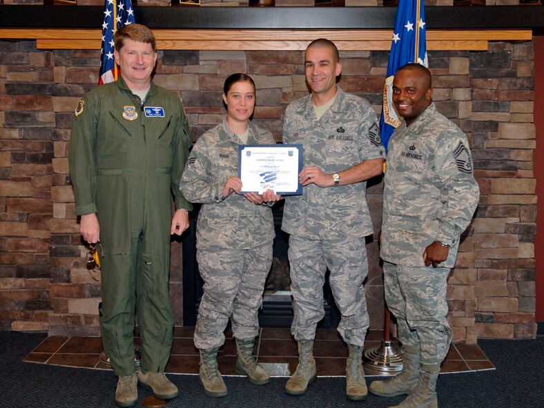 FAIRCHILD AIR FORCE BASE, Wash. – Col. Robert Thomas, 92nd Air Refueling Wing commander, and Chief Master Sgt. Michael Davis, 92nd Mission Support Group superintendant, present Senior Airman Melissa Rush, 92nd Force Support Squadron personnel technician, with the Diamond Sharp award, Aug. 11. Master Sgt. Christopher Leo, 92nd FSS first sergeant, nominated Airman Rush for her dedication and professionalism in supervising three Airmen after graduating Airman Leadership School. (U.S. Air Force photo / Airman 1st Class Melissa L. Carlino)
