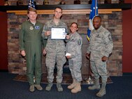 FAIRCHILD AIR FORCE BASE, Wash. – Col. Robert Thomas, 92nd Air Refueling Wing commander, and Chief Master Sgt. Michael Davis, 92nd Mission Support Group superintendant, present Senior Airman Nick Waggle, 336th Training Support Squadron Survival, Evasion, Rescue and Escape supply, with the Diamond Sharp award  Aug. 11. Master Sgt. Carol Davis, 336th TRSS first sergeant, nominated Senior Amn. Waggle for his superior work performance, managing a half-million dollar S.E.R.E supply budget and selflessly volunteering for ‘Survival Against Drunk Driving’. (U.S. Air Force photo / Airman 1st Class Melissa L. Carlino)