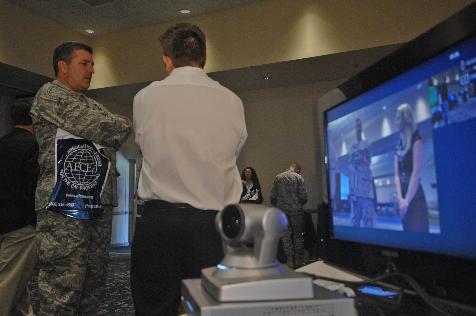 VANDENBERG AIR FORCE BASE, Calif. – Talking about video teleconferencing equipment, Lt. Col. Jim Vasconcellos, the 14th Air Force chief of intelligence, surveillance and reconnaissance operations, browses vendor’s products during the Space/Communications Integration Symposium on Aug. 18 here. The symposium was held to stimulate local interest in communications, electronics and intelligence as they relate to the space mission. (U.S. Air Force photo/Staff Sgt. Levi Riendeau)