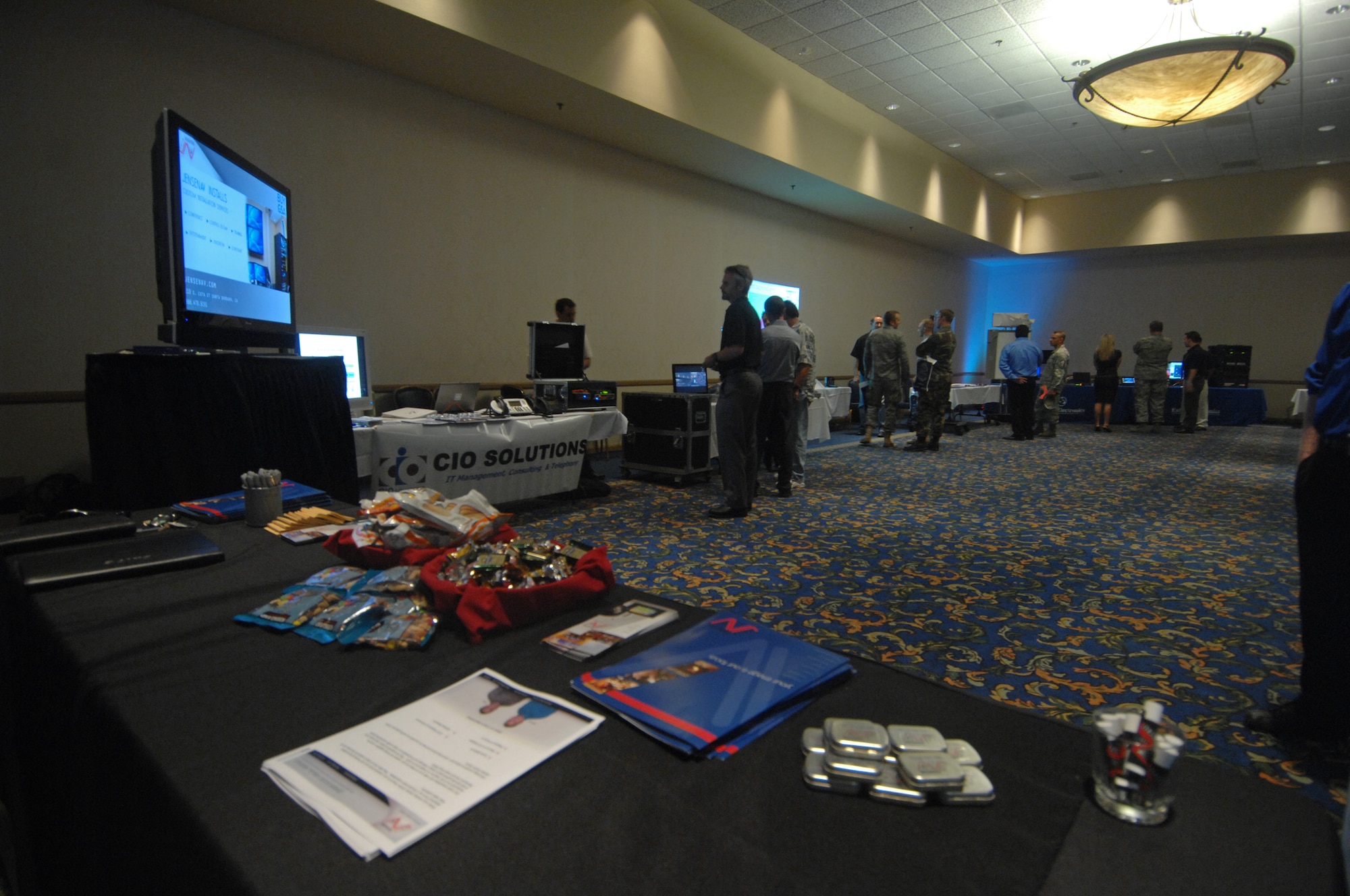 VANDENBERG AIR FORCE BASE, Calif. -- Vandenberg personnel check vendor's products at the Space/Communications Integration Symposium on Aug. 18 here. The symposium was held to stimulate local interest in communications, electronics and intelligence as they relate to the space mission. (U.S. Air Force photo/Staff Sgt. Levi Riendeau)