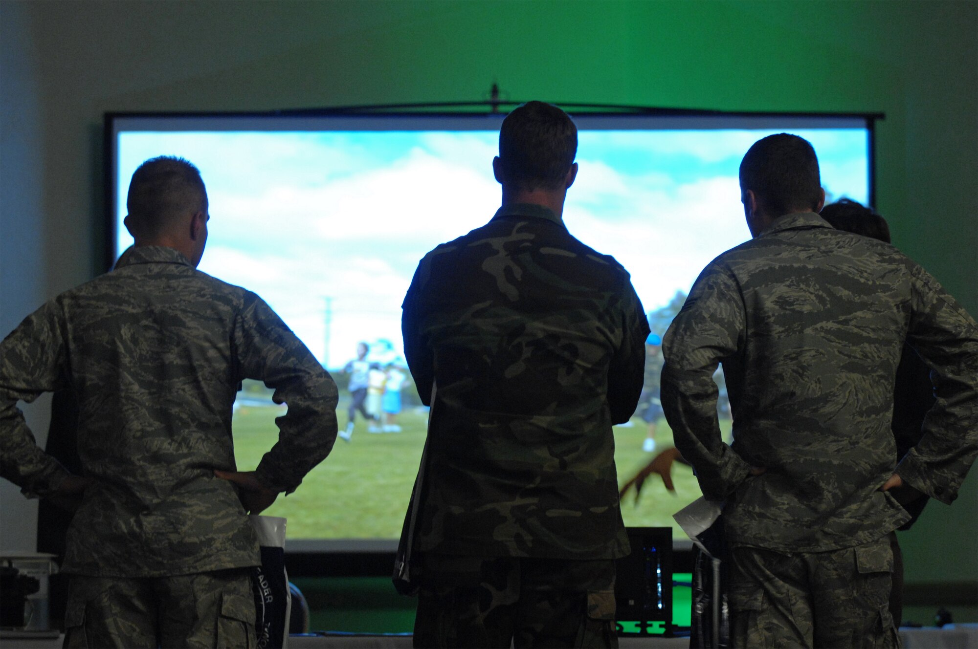 VANDENBERG AIR FORCE BASE, Calif. -- Vandenberg personnel watch a high-definition projector image during the Space/Communications Integration Symposium on Aug. 18 here. The symposium was held to stimulate local interest in communications, electronics and intelligence as they relate to the space mission. (U.S. Air Force photo/Staff Sgt. Levi Riendeau)