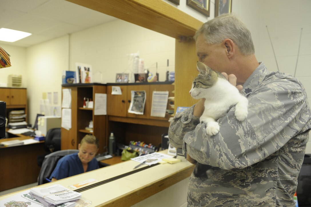 Lt. Col. Rory Adams, 28th Bomb Wing strategic arms reduction talks treaty officer, brings his cat Duncan, to the vet clinic here, August 20. The clinic performs routine checkups and vaccinations for many pets on and off base. (U.S. Air Force photo by Airman 1st Class Corey Hook)