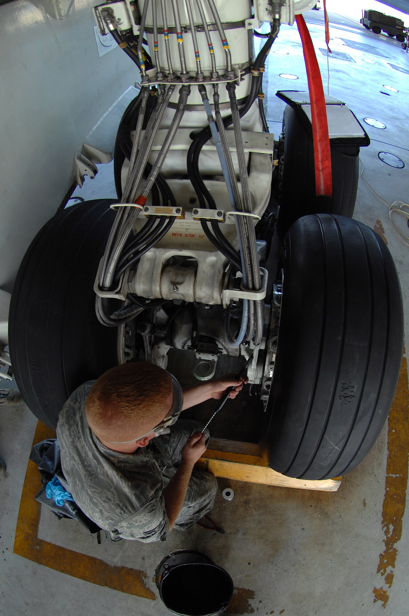 WHITEMAN AIR FORCE BASE, Mo. – Airman 1st Class Benjamin Feldkamp, 509th Aircraft Maintenance Squadron crew chief, safety wires a break bleed port on a B-2 Spirit prior to takeoff, Aug. 22, 2009. Airman Feldkamp and other AMXS crew chiefs work around the clock to ensure the B-2 Spirit is mission ready at all times. (U.S. Air Force photo/Senior Airman Kenny Holston)