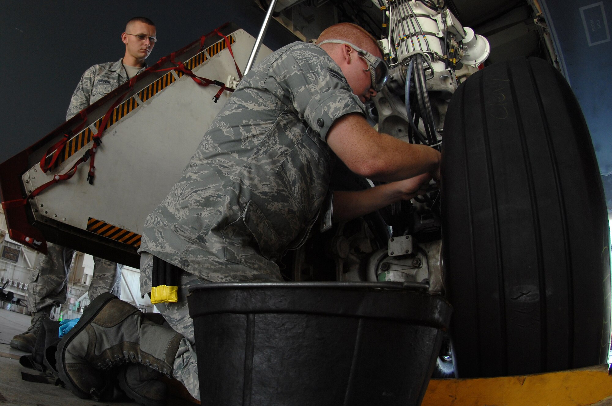 WHITEMAN AIR FORCE BASE, Mo. – Airman 1st Class Benjamin Feldkamp, 509th Aircraft Maintenance Squadron crew chief, safety wires a break bleed port on a B-2 Spirit prior to takeoff, Aug. 22, 2009. Airman Feldkamp and other AMXS crew chiefs work around the clock to ensure the B-2 Spirit is mission ready at all times. (U.S. Air Force photo/Senior Airman Kenny Holston))