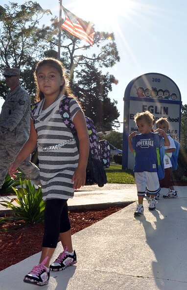 EGLIN AIR FORCE BASE, Fla. – Children rush to begin their first day back in school Aug. 24, at Eglin Elementary School. Drivers are reminded to keep a careful eye out as children will be to and from bus stops in the mornings and afternoons. Eglin drivers should slow down and stop for school buses and remain alert for children crossing. (U.S. Air Force photo/ Airman Anthony Jennings)