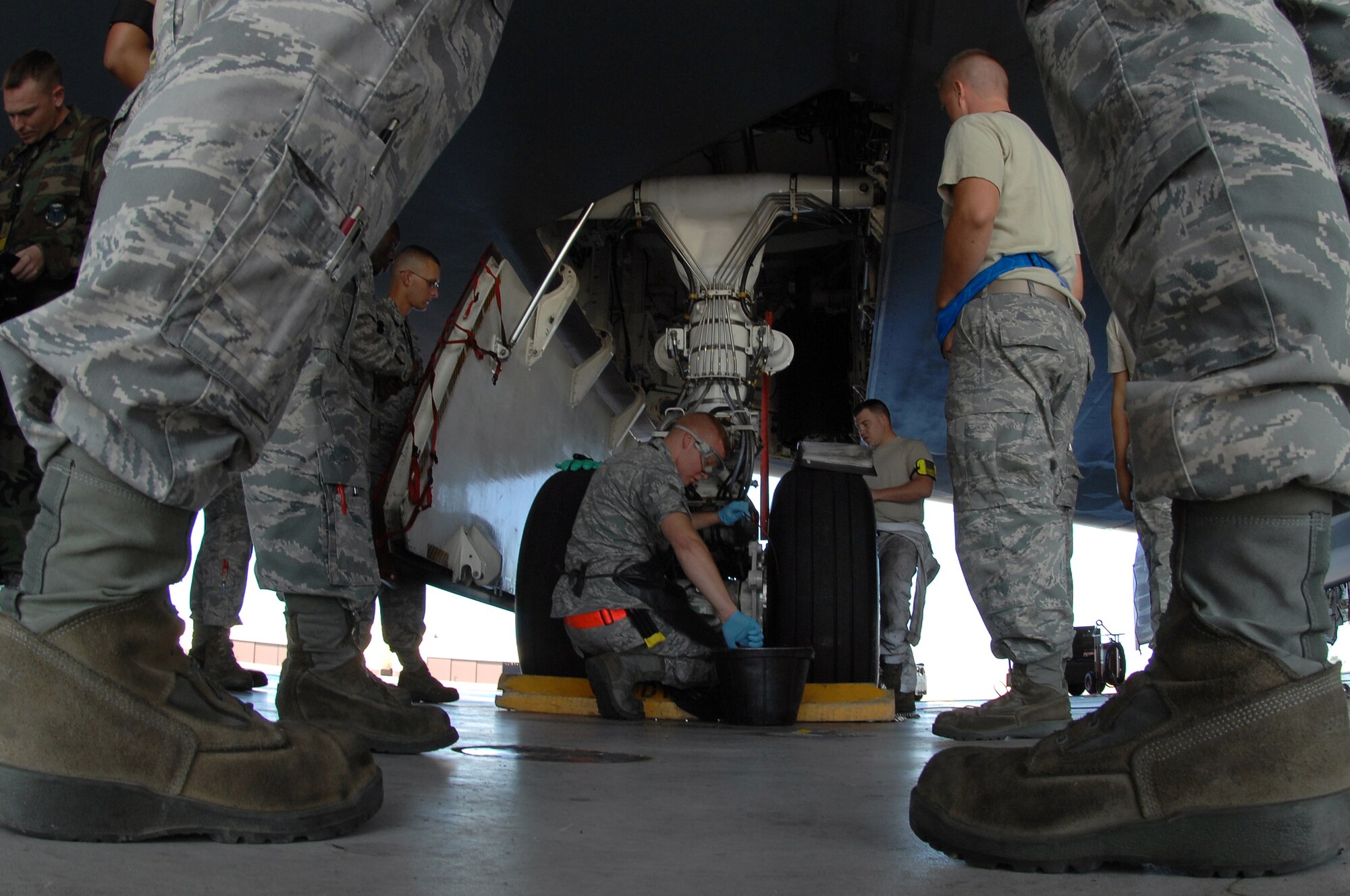 WHITEMAN AIR FORCE BASE, Mo. – Airman 1st Class Benjamin Feldkamp (center), 509th Aircraft Maintenance Squadron crew chief, safety wires a break bleed port on a B-2 Spirit prior to take off, Aug. 22, 2009. Airman Feldkamp and other AMXS crew chiefs work around the clock to ensure the B-2 Spirit is mission ready at all times. (U.S. Air Force photo/Senior Airman Kenny Holston)