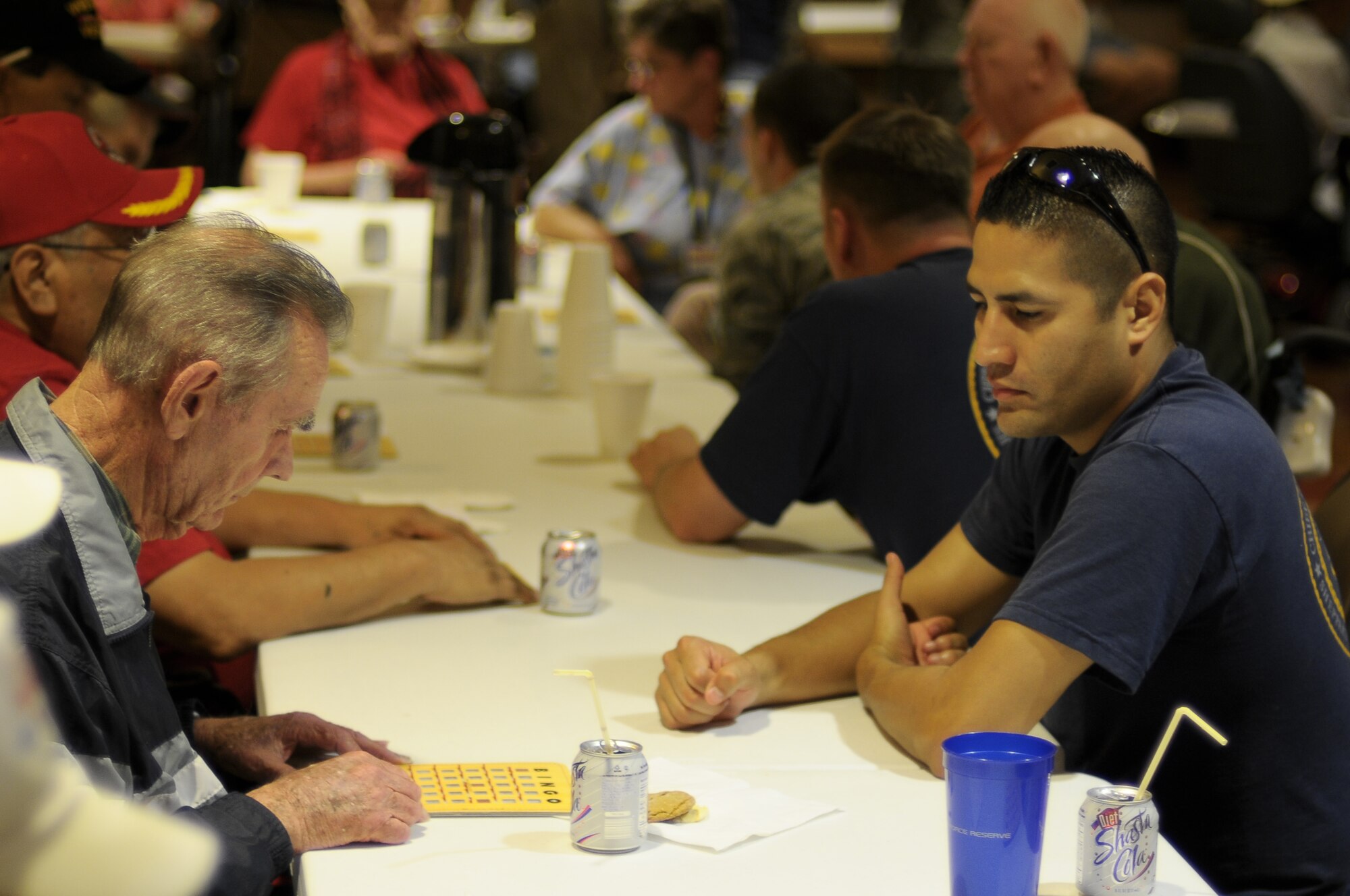 Navy Cheif Petty Officer Paul Ramirez, 366th Training Squadron, plays bingo with military veterans Aug. 20 at the Veteran's Center in Lawton, Okla. Sheppard's Top-3 teamed up with their colleagues from Altus Air Force Base, Okla. to show veterans their service has not been forgotten when they visited the long-term nursing center. Coincidentally, Sheppard's Navy chiefs were also at the center to show their chief-selects that it is important to remember history and honor those who served before them. (U.S. Air Force photo/Tech. Sgt. Matthew Beauregard)