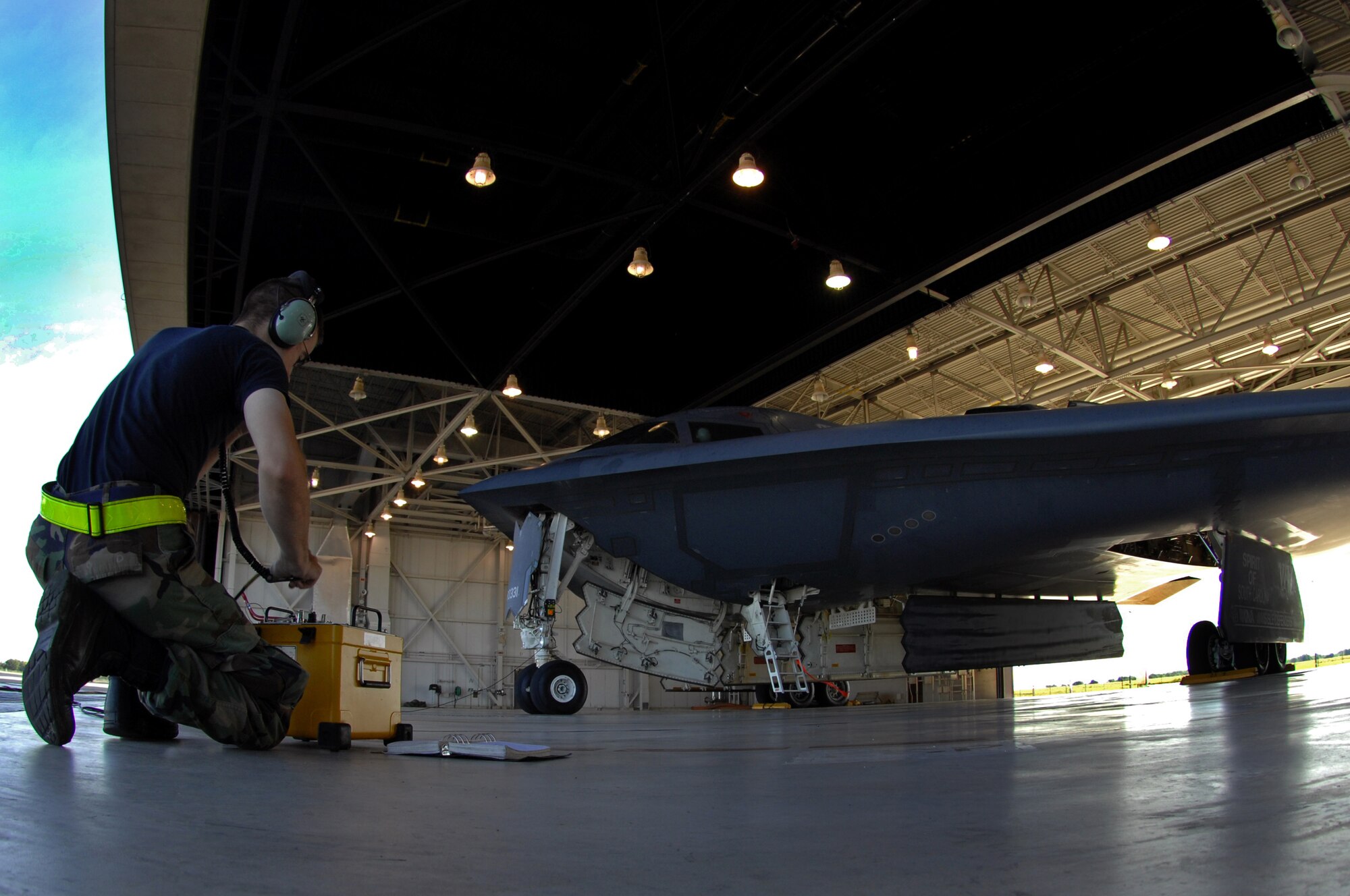 WHITEMAN AIR FORCE BASE, Mo. – A crew chief with the 509th Aircraft Maintenance Squadron performs a pre-flight check on a B-2 Spirit prior to takeoff, Aug. 22, 2009. Twenty B-2 bombers are assigned to the 509th Bomb Wing here. The B-2 brings massive firepower to bear, in a short time, anywhere on the globe through previously impenetrable defenses. (U.S. Air Force photo/Senior Airman Kenny Holston)