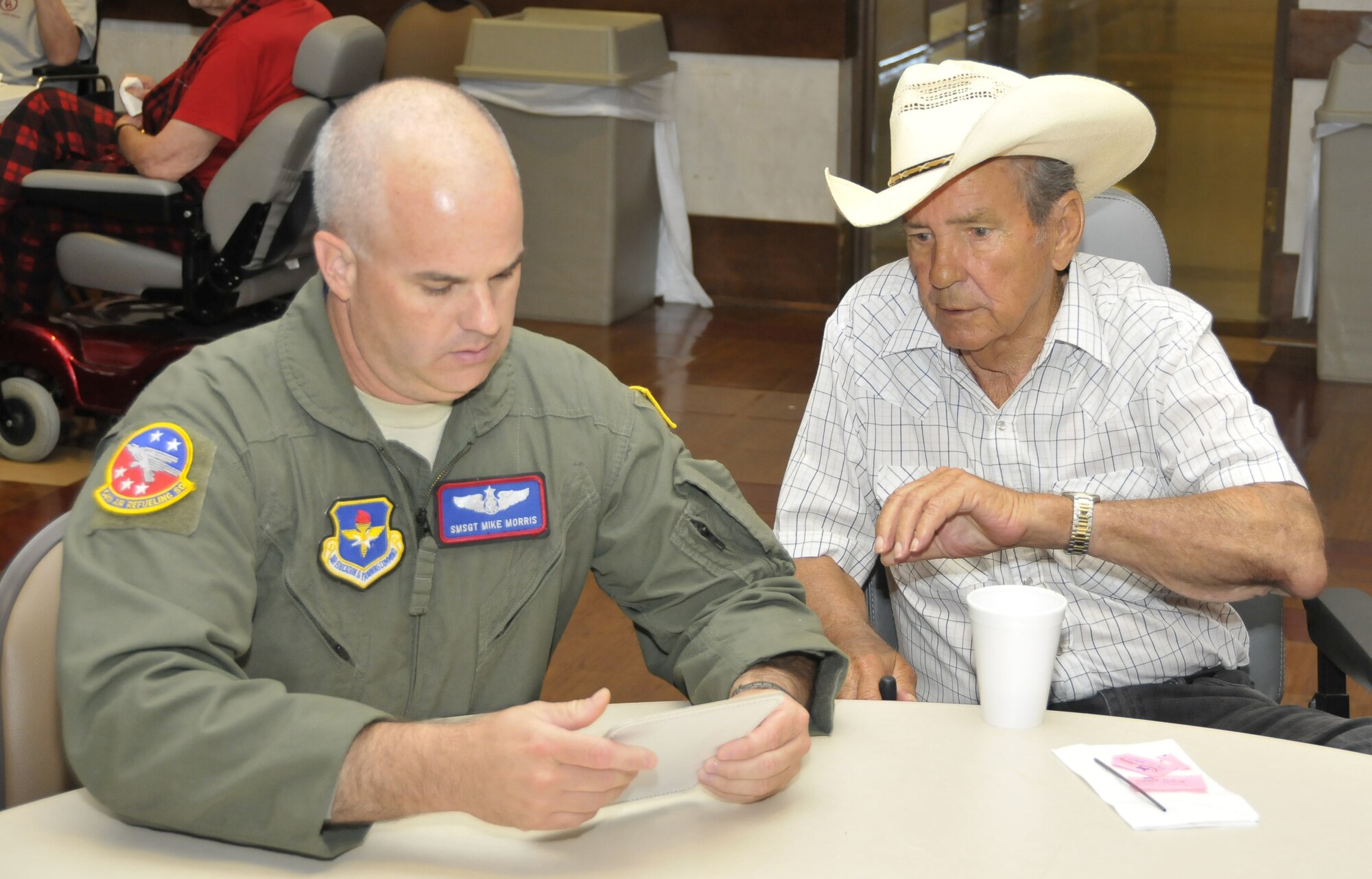 Senior Master Sgt. Mike Morris, 54th Air Refueling Squadron at Altus Air Force Base, Okla., plays bingo with military veterans Aug. 20 at the Veteran's Center in Lawton, Okla. Sheppard's Top-3 teamed up with their colleagues from Altus Air Force Base, Okla. to show veterans their service has not been forgotten when they visited the long-term nursing center. (U.S. Air Force photo/Tech. Sgt. Matthew Beauregard)