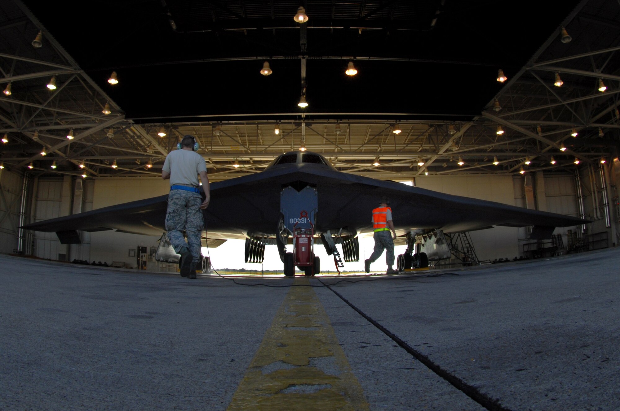 WHITEMAN AIR FORCE BASE, Mo. -- Senior Airman Douglas Anthony and Airman Kyle Joyner, both 509th Aircraft Maintenance Squadron crew chiefs, perform pre-flight checks on a B-2 Spirit prior to takeoff, Aug. 22, 2009. Twenty B-2 bombers are assigned to the 509th Bomb Wing. The B-2 brings massive firepower to bear, in a short time, anywhere on the globe through previously impenetrable defenses. (U.S. Air Force photo/Senior Airman Kenny Holston)