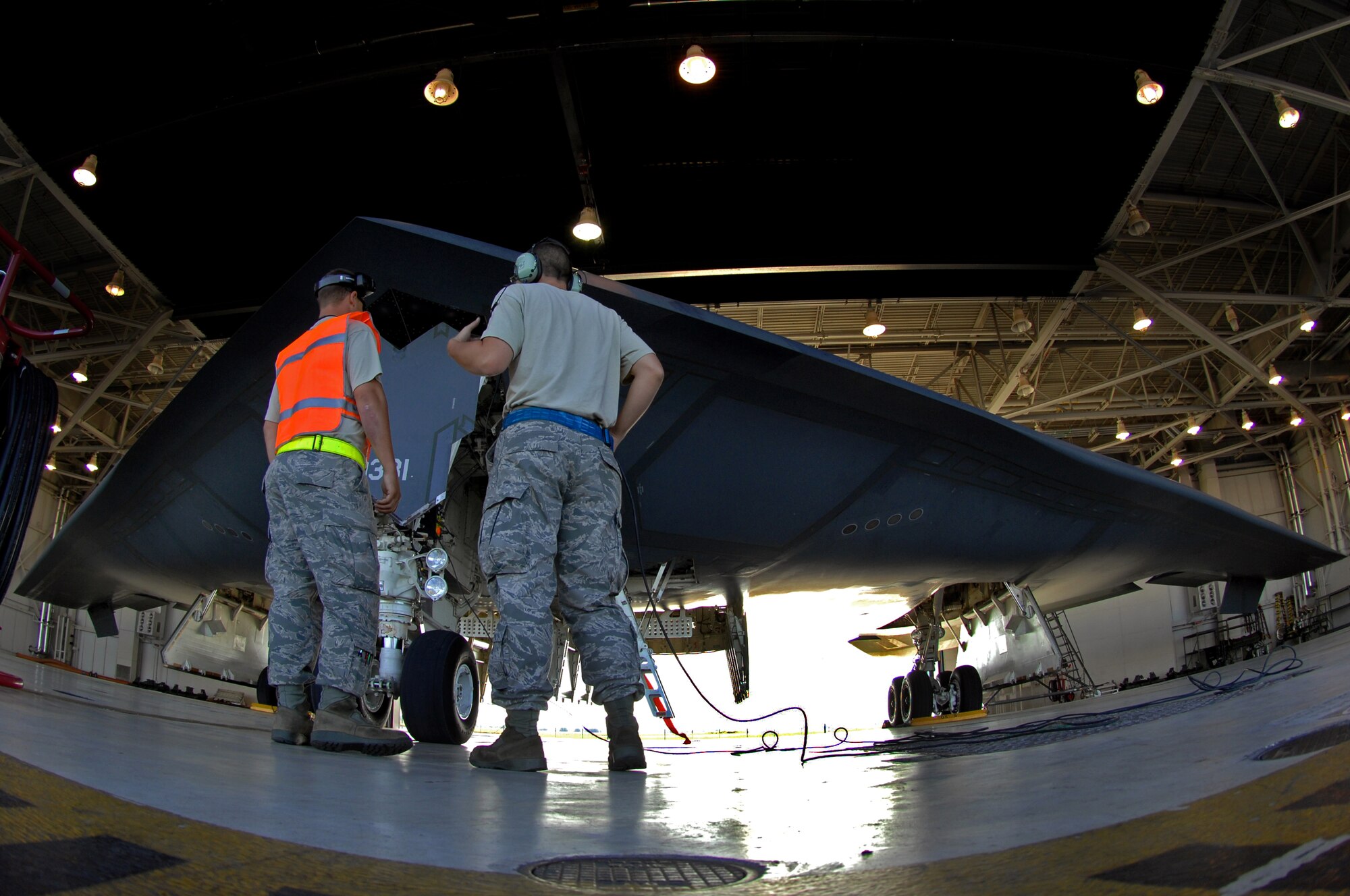 WHITEMAN AIR FORCE BASE, Mo. -- Senior Airman Douglas Anthony and Airman Kyle Joyner, both 509th Aircraft Maintenance Squadron crew chiefs, discuss pre-flight checks on a B-2 Spirit prior to takeoff, Aug. 22, 2009. Twenty B-2 bombers are assigned to the 509th Bomb Wing. The B-2 brings massive firepower to bear, in a short time, anywhere on the globe through previously impenetrable defenses. (U.S. Air Force photo/Senior Airman Kenny Holston)